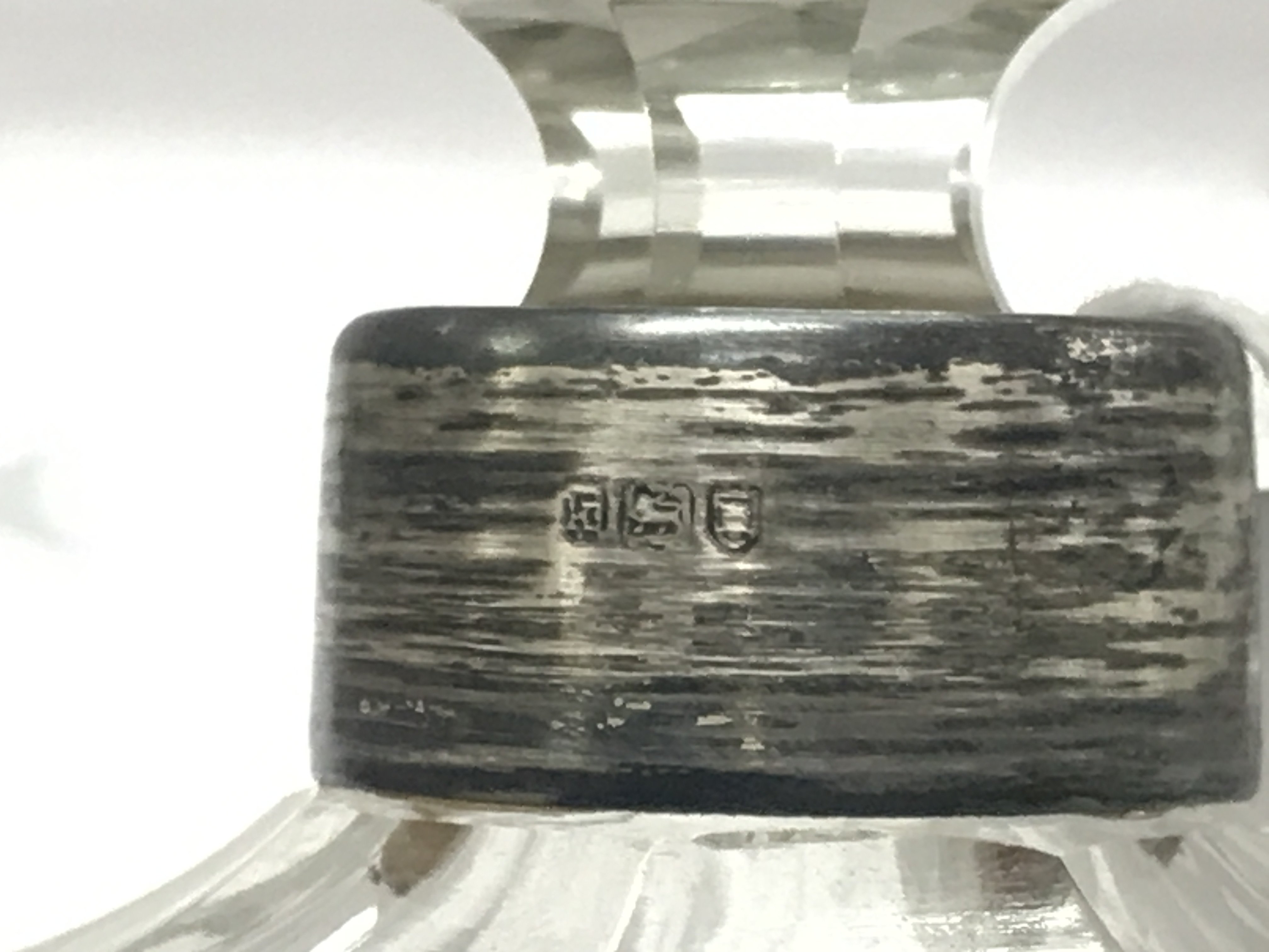 A silver Hallmarked topped cut crystal glass bottle , this lot cannot be posted