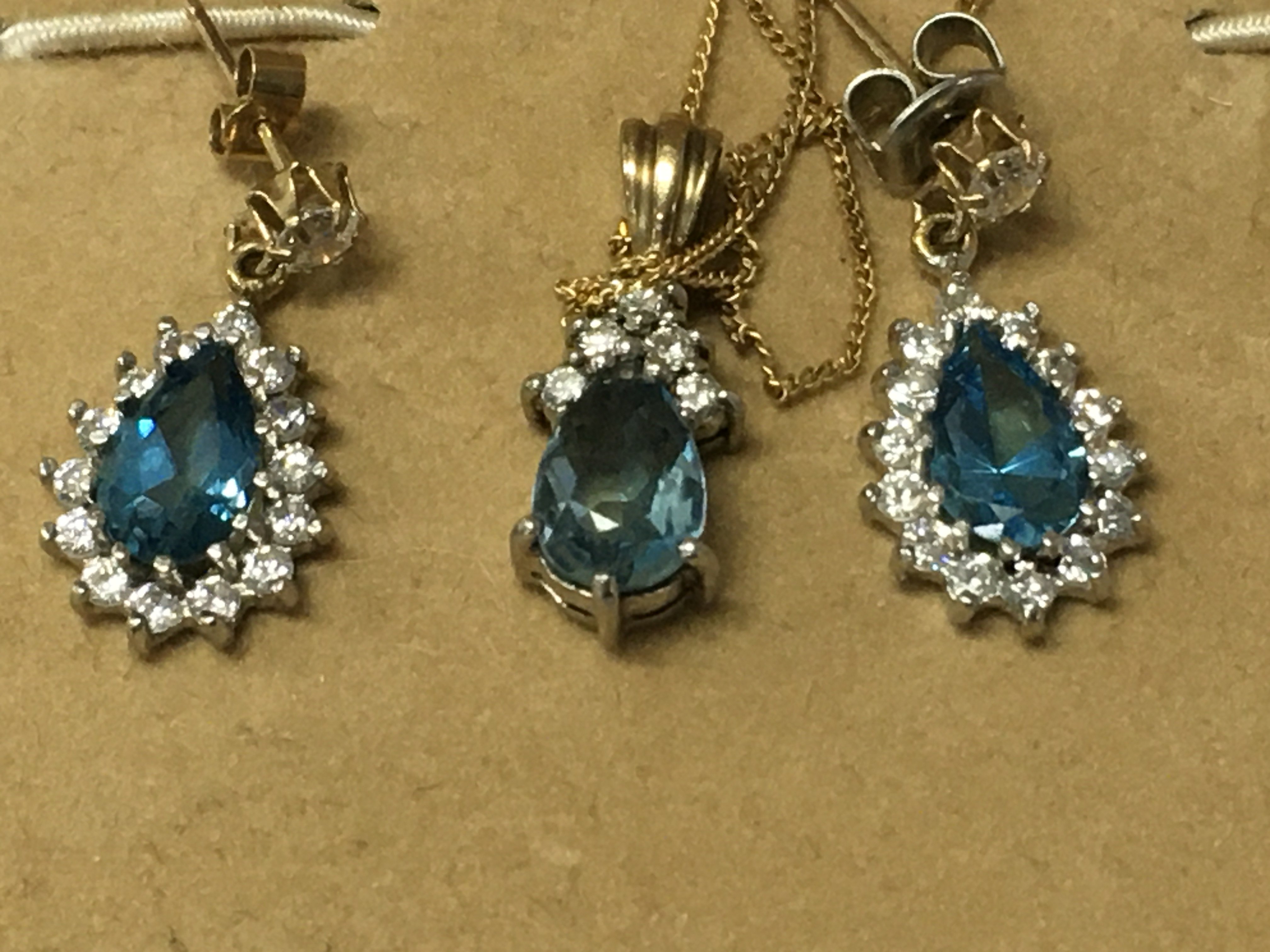 A aquarium pear shaped pendant with diamonds mounted on a 9ct gold chain with a matching Pair of earrings.