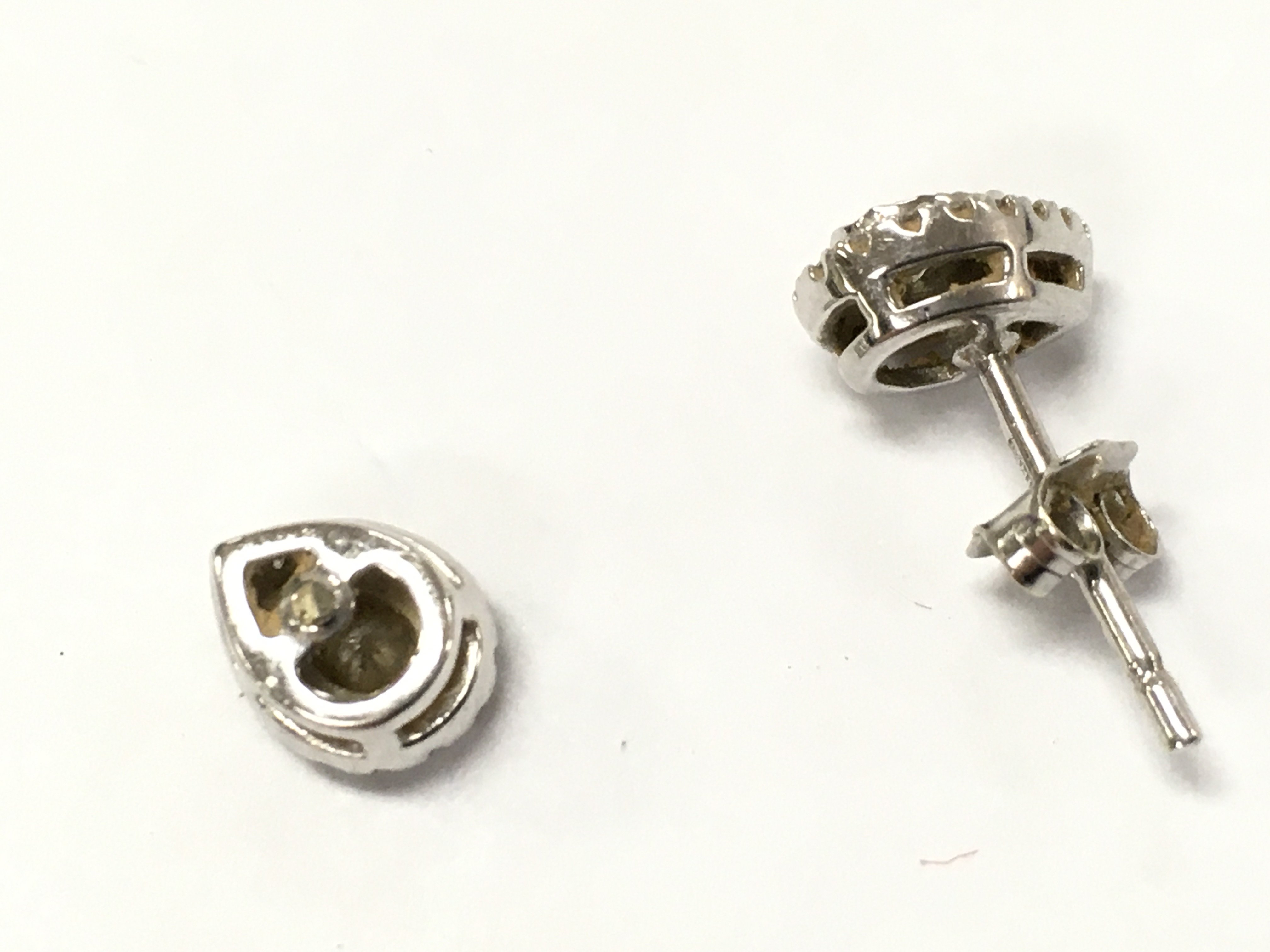 9ct gold tear drop diamond studs, one damaged . Total weight 1.18g . Postage category A- NO RESERVE