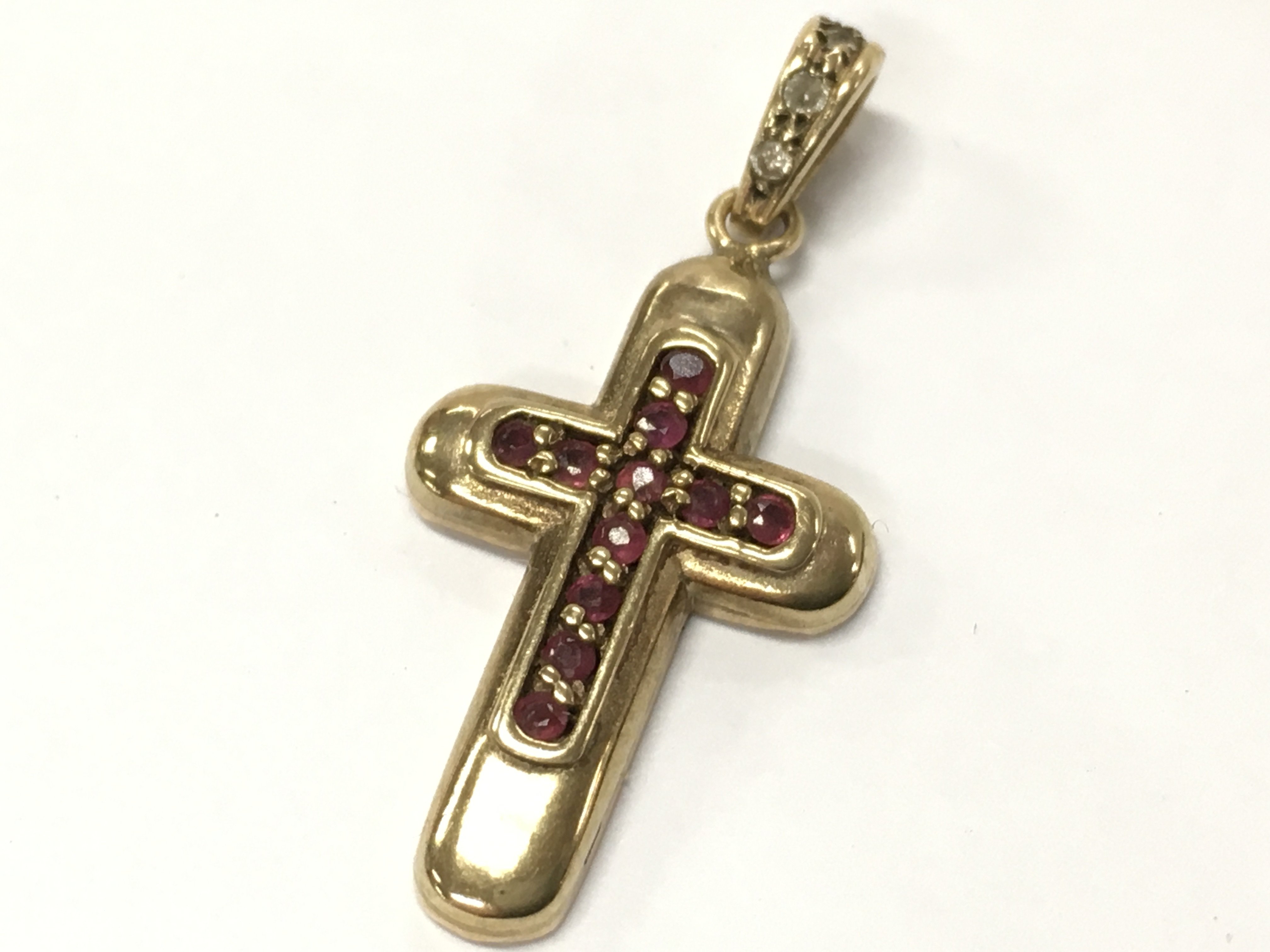 A gold pendant set with rubies and diamonds . 3.5g total weight. Postage category A