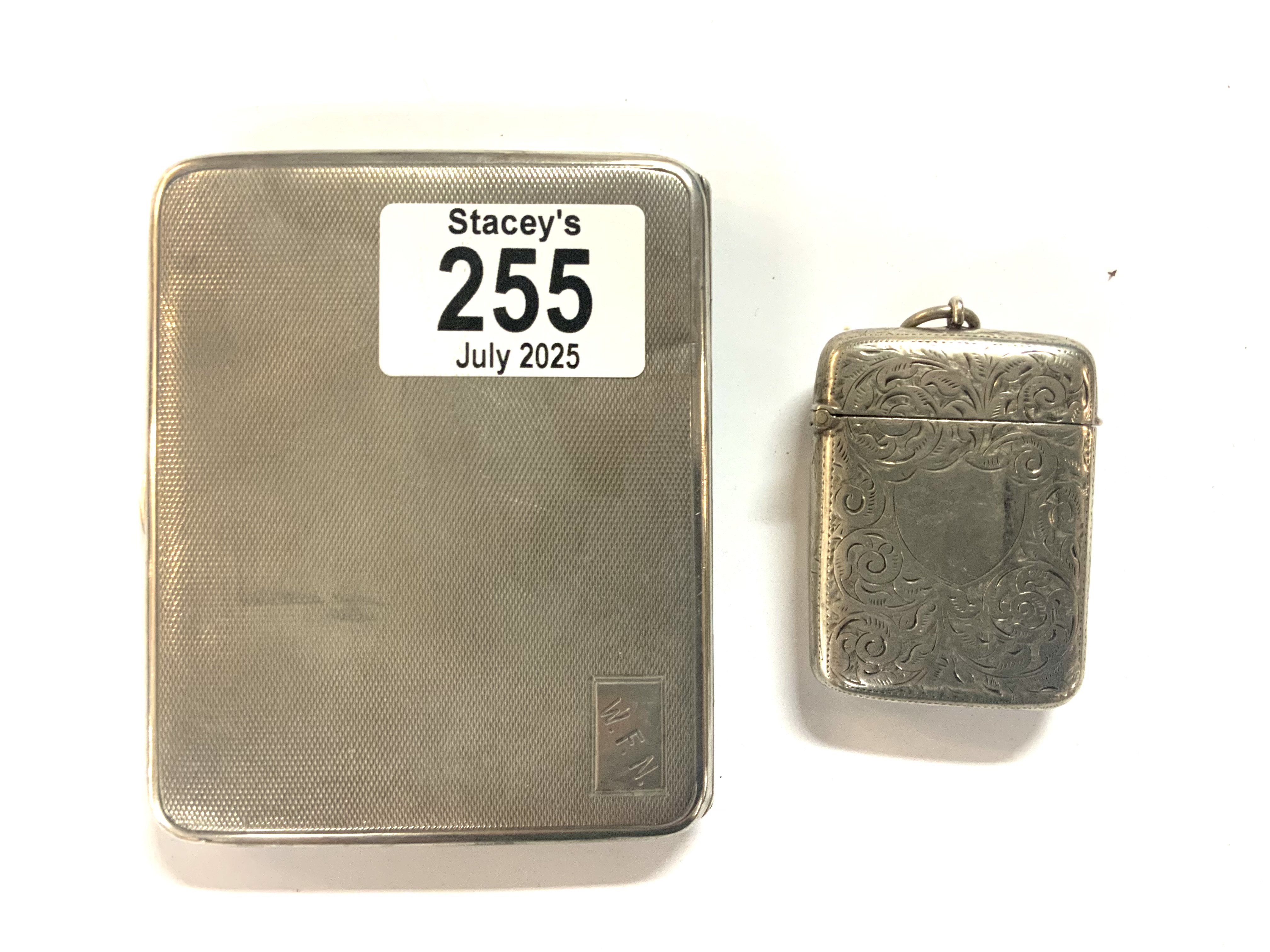 A hallmarked silver cigarette case and vesta case.