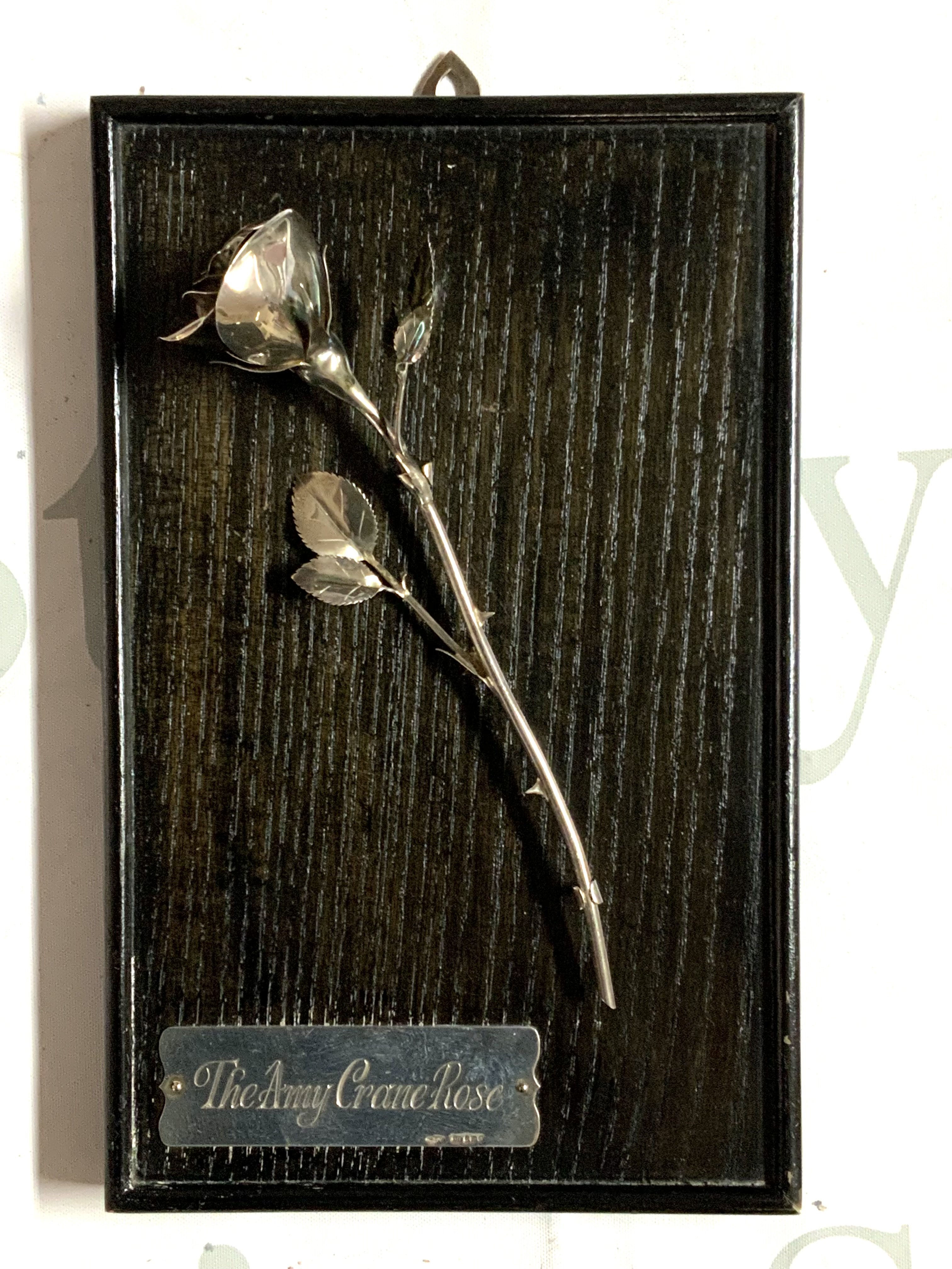 A framed set of hallmarked silver and enamel teaspoons together with a silver model of The Amy Crane Rose mounted on a wooden panel- NO RESERVE