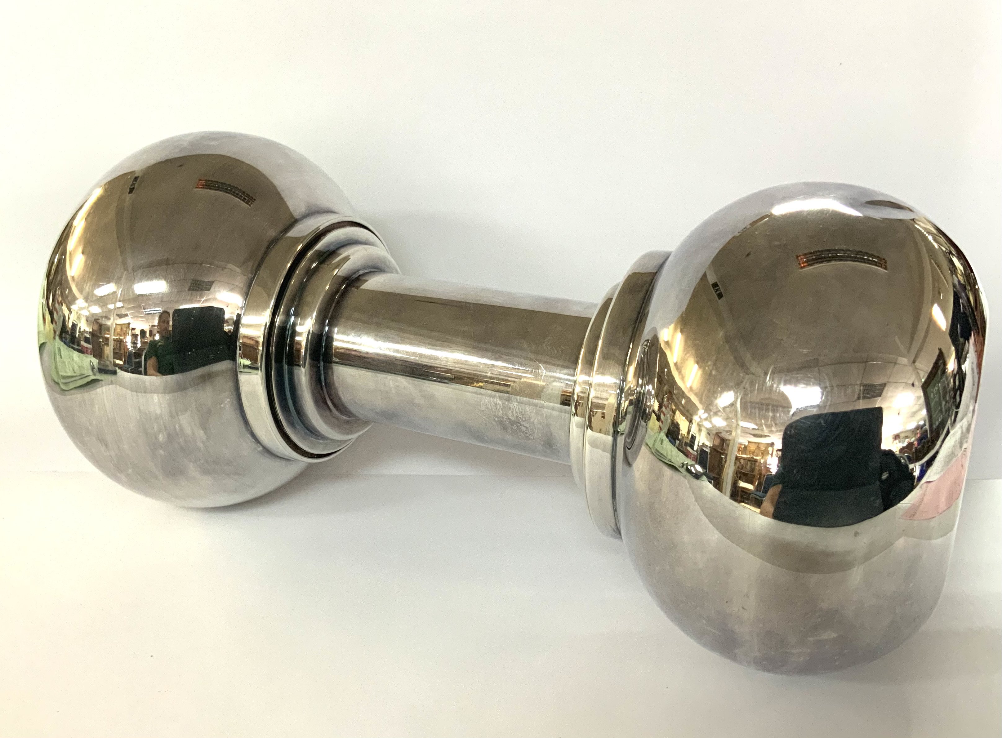 A Silver plated DUMBBELL COCKTAIL SHAKER Asprey, circa 1930 Modelled as a dumbbell, one end with a removable strainer, height 26cm.