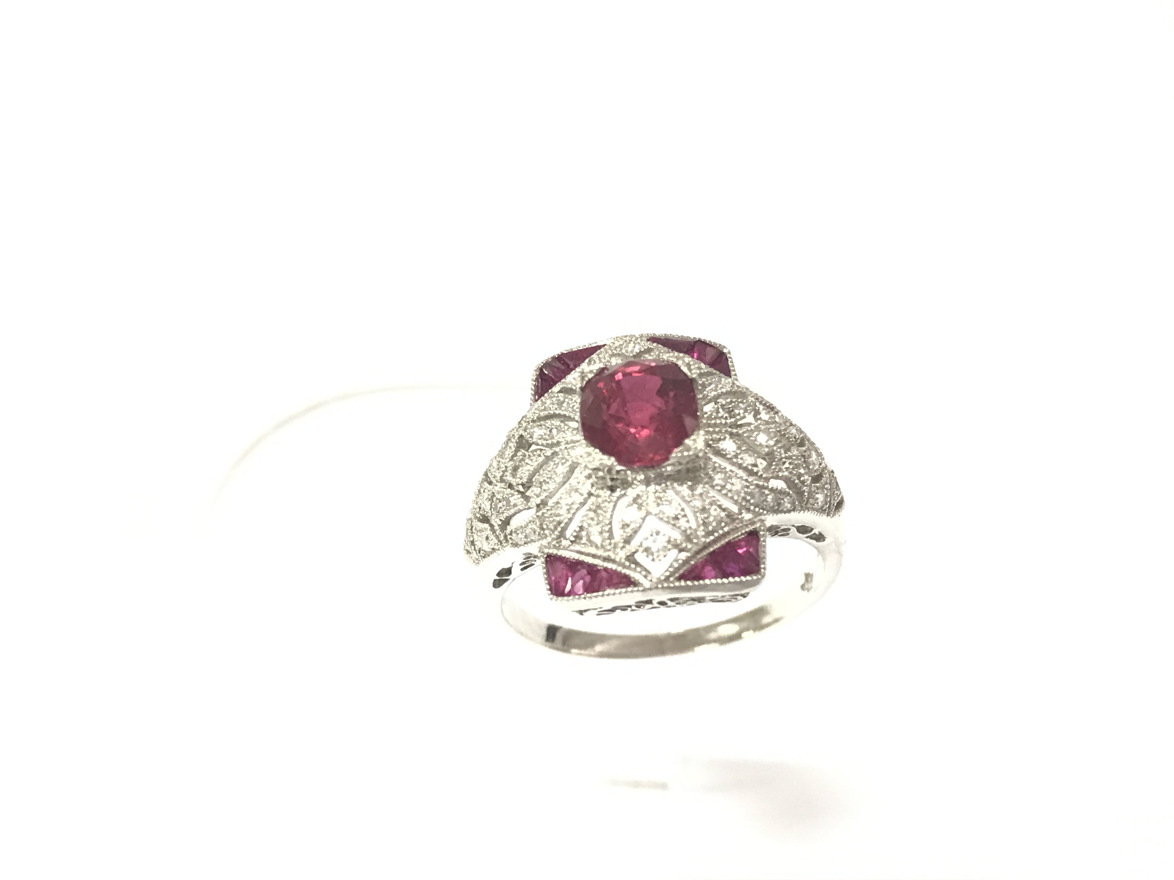 A Victorian style platinum Ruby and diamond dress ring with an ornate setting. Rubies 1ct and diamonds 0.58ct approximately. Size M 1/2.Postage B