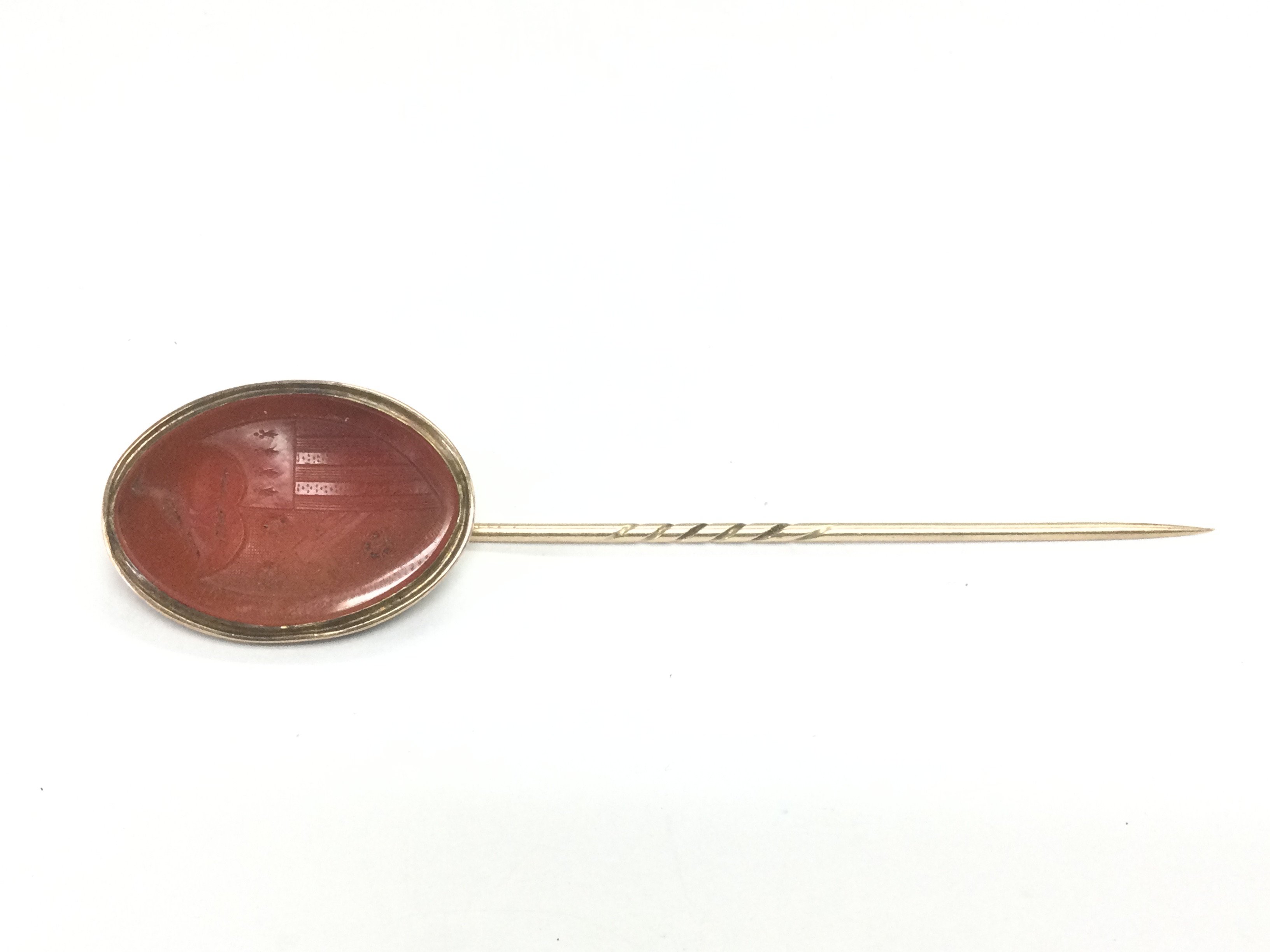 A gold stick pin with intaglio cut agate mount. Shipping category A.