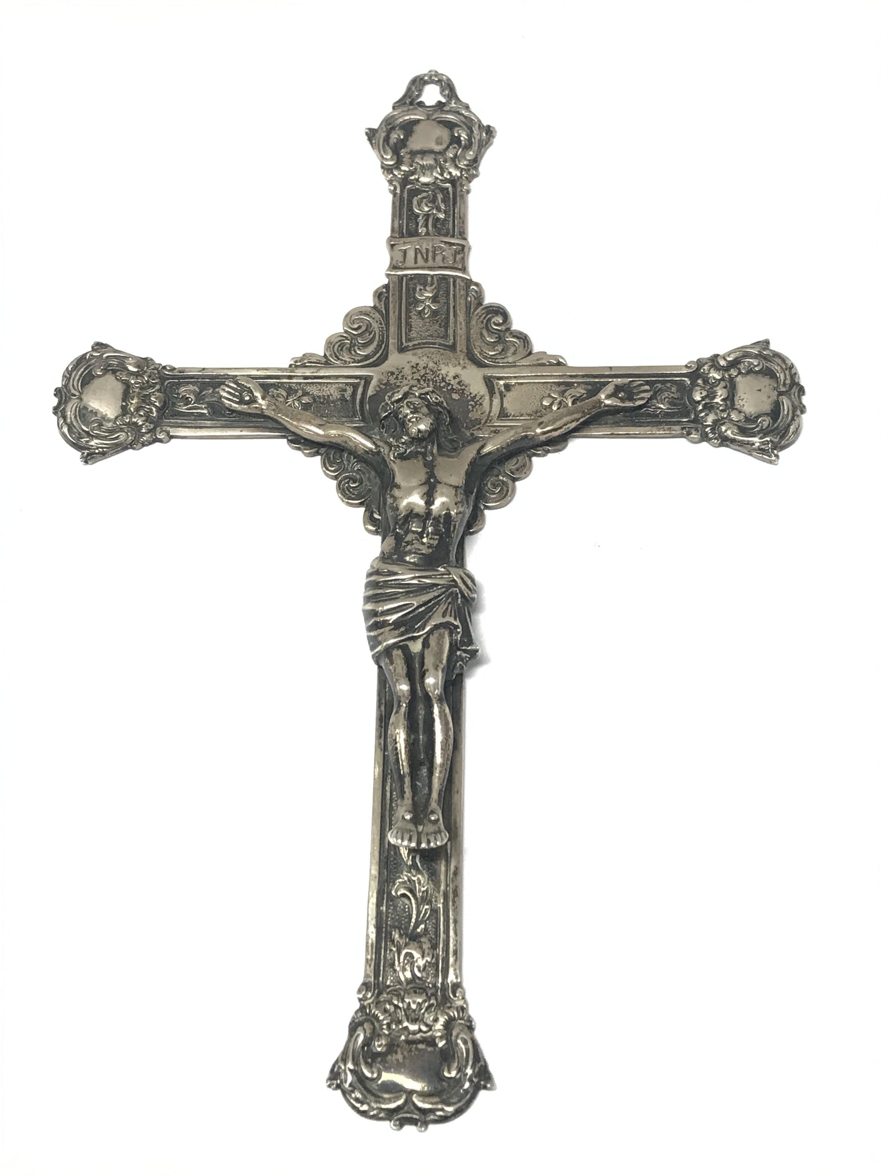 A silver crucifix 20cm tall 13cm wide , postage category B