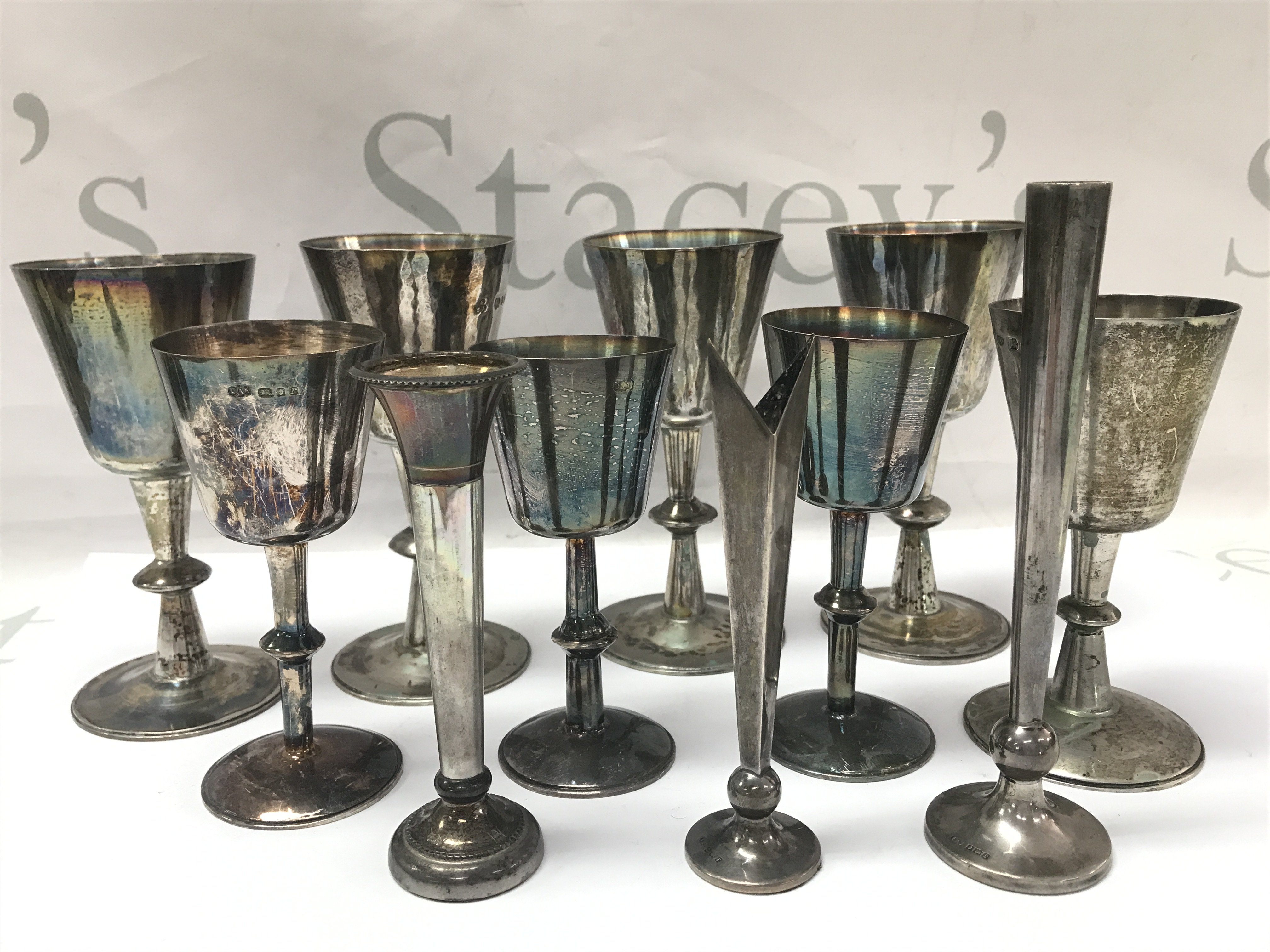A collection of silver hallmarked Cups (tallest 14cm) and flower vases. Postage category B