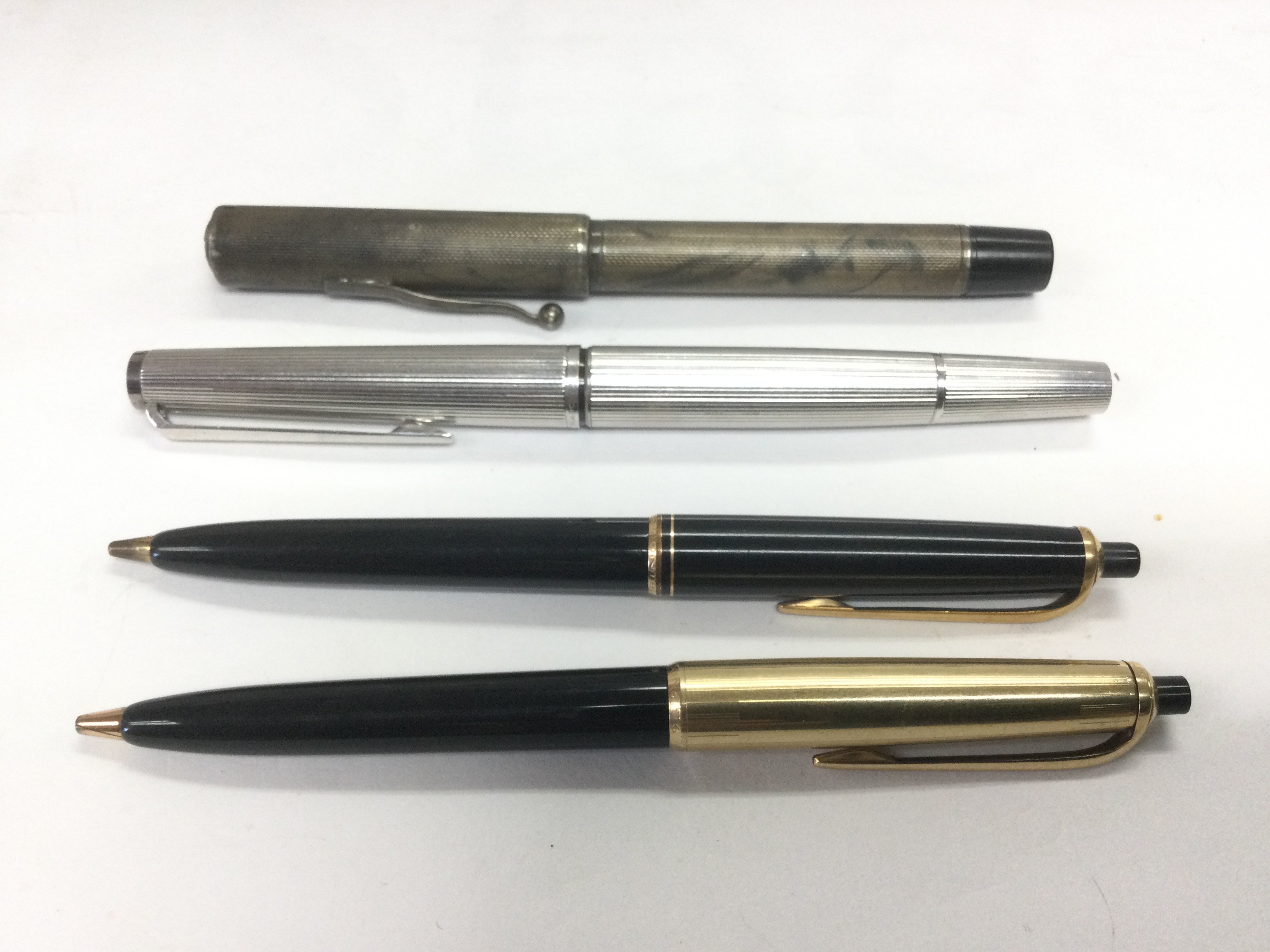 Two Mont Blanc pens and two others including a silver cased example. Shipping category A.