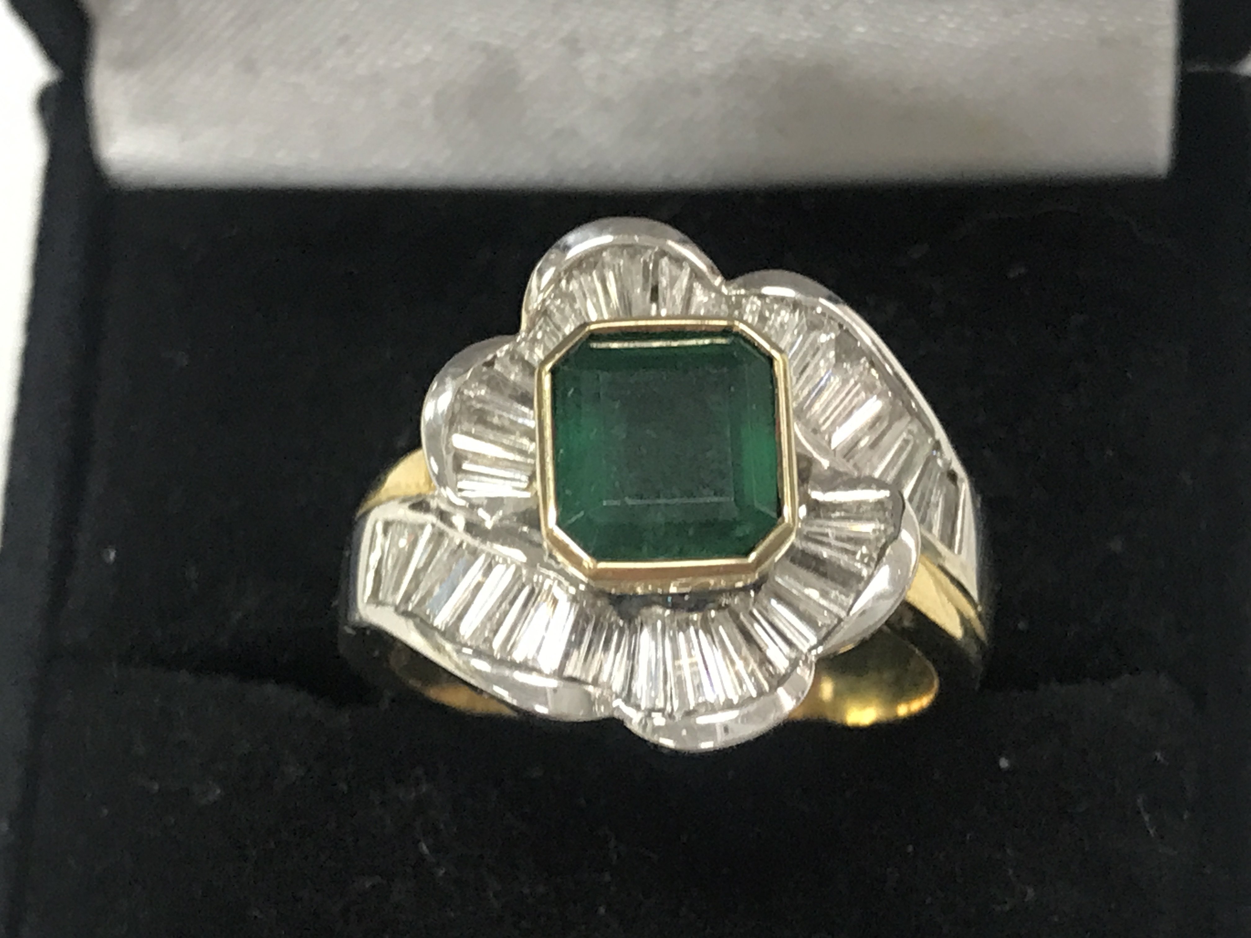 An 18ct gold emerald and diamond ring with valuation report. Size S. 12g total weight. postage catA