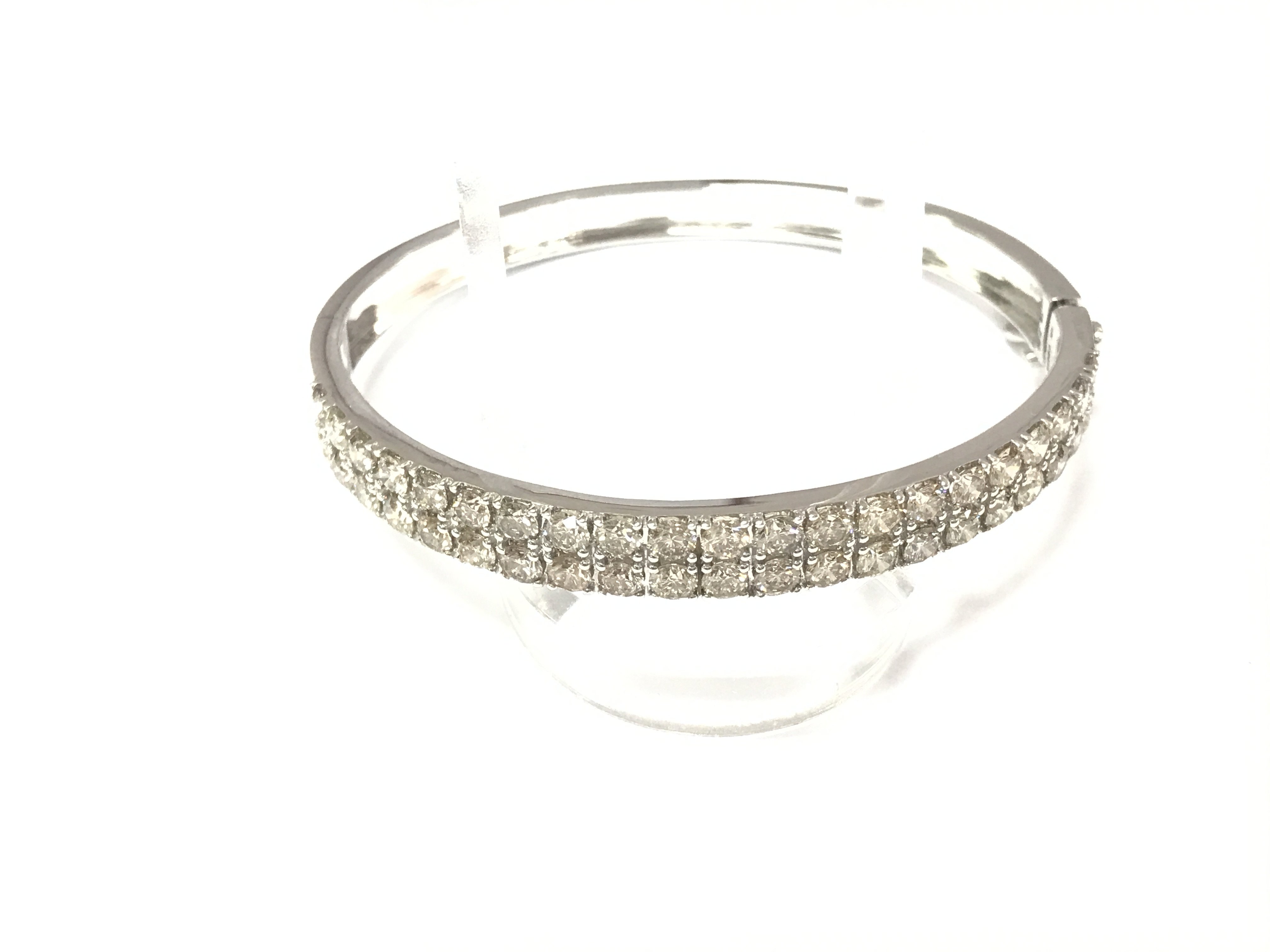 A 9ct white gold bangle set with two rows of diamonds. Diamonds approx 7ct and bangle has diameter of 6.5cm