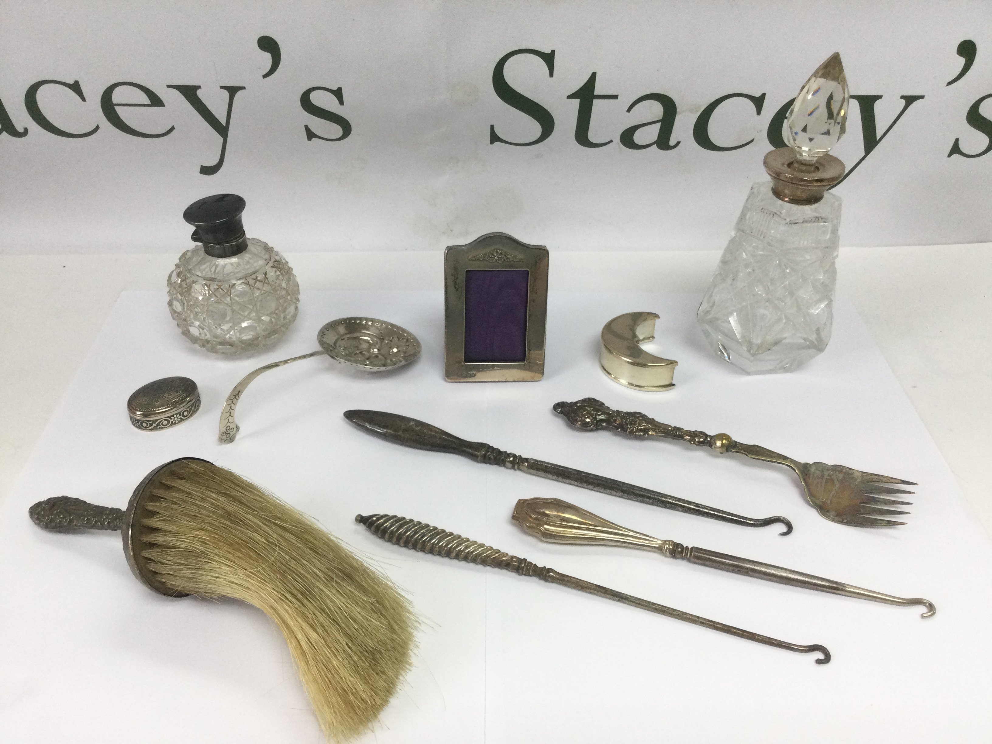 A collection of mixed silver and glass items including a Tiffany half moon shaped box, perfume bottles etc. Shipping category D.