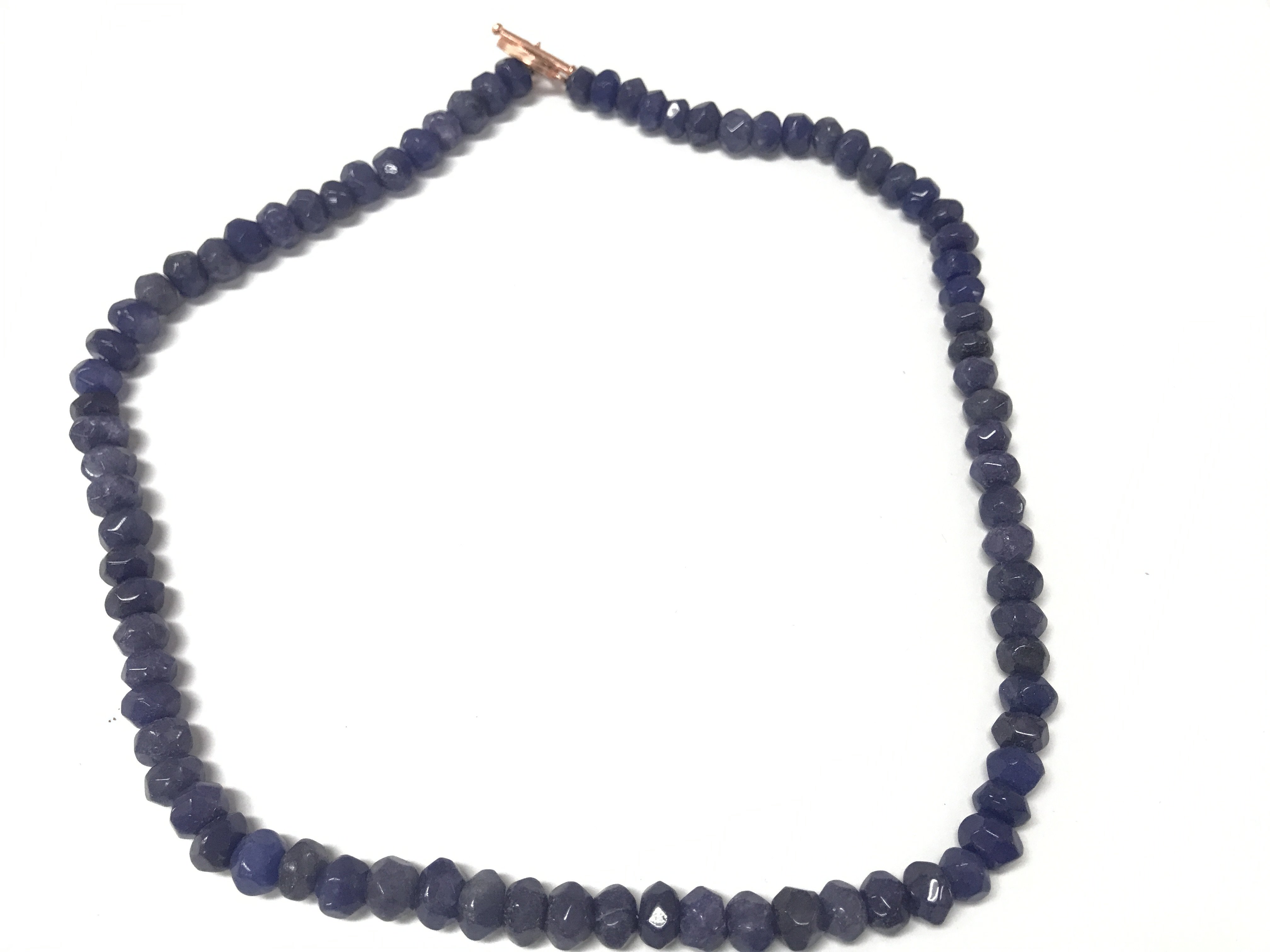 A necklace strung with faceted reconstituted blue onyx beads with a rose and bar clasp. Approximately 350 ct onyx.
