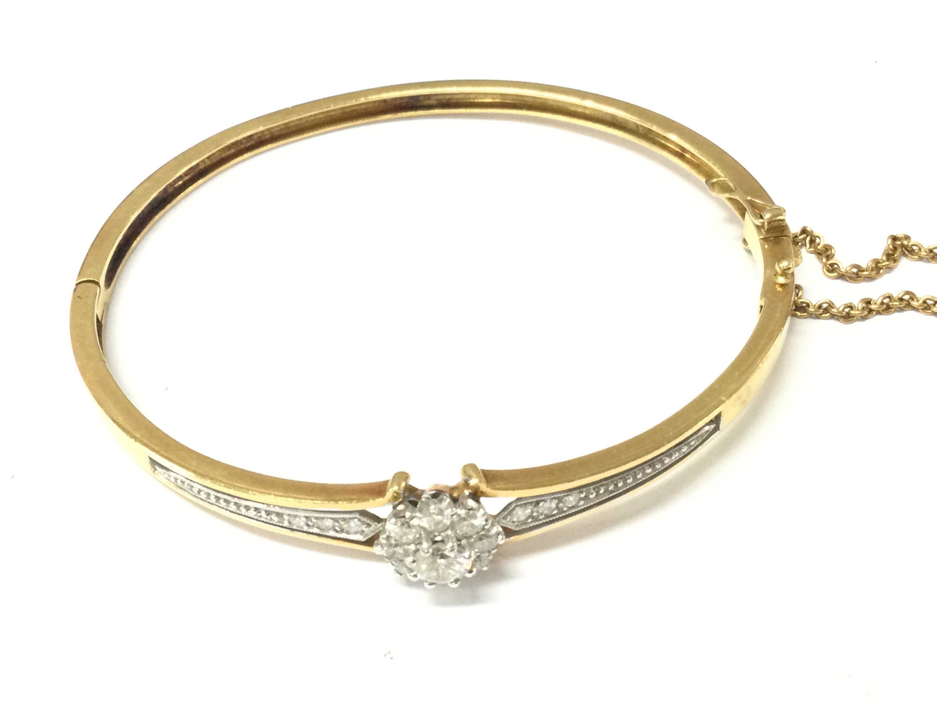 An 18ct gold Edwardian diamond bangle. 18.71g and approximately 6.5cm diameter. Postage B