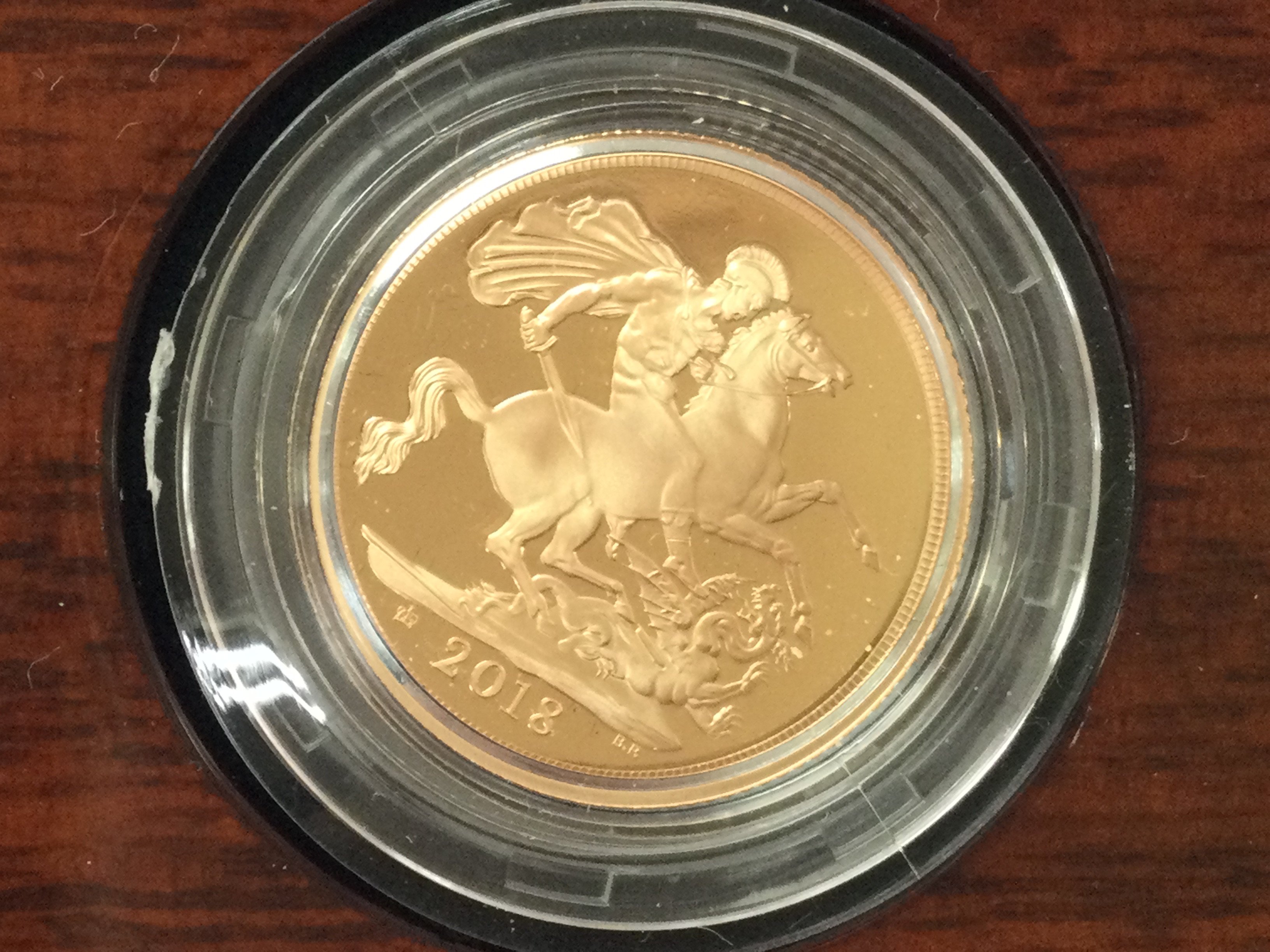 A 2018 gold proof sovereign with box and COA. Postage B