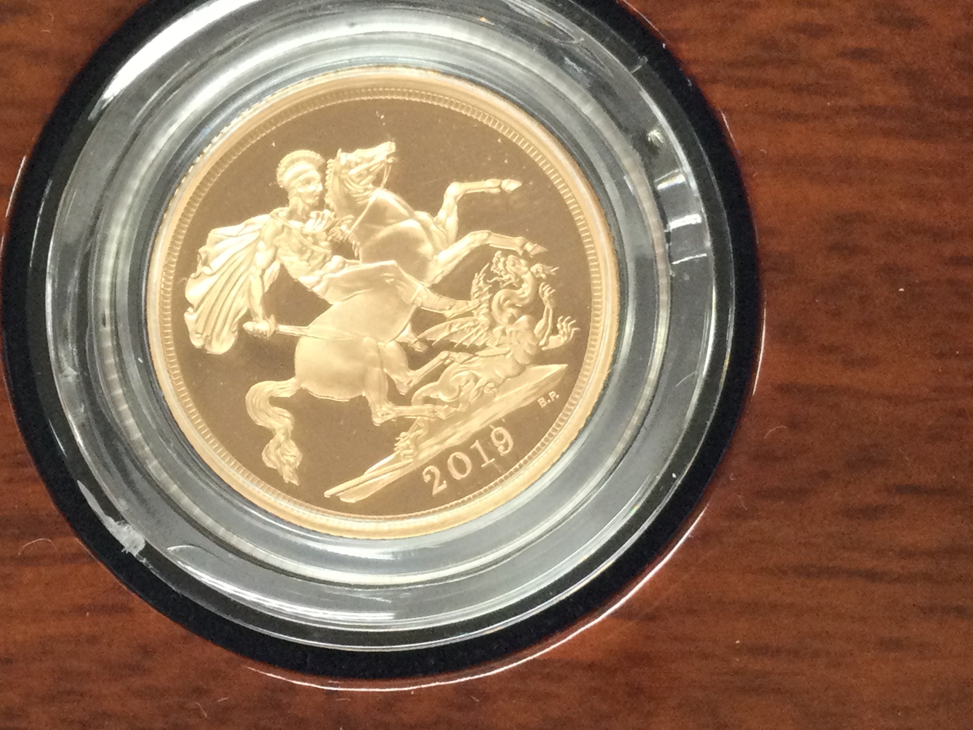 A 2019 gold proof sovereign with box and COA. Postage B