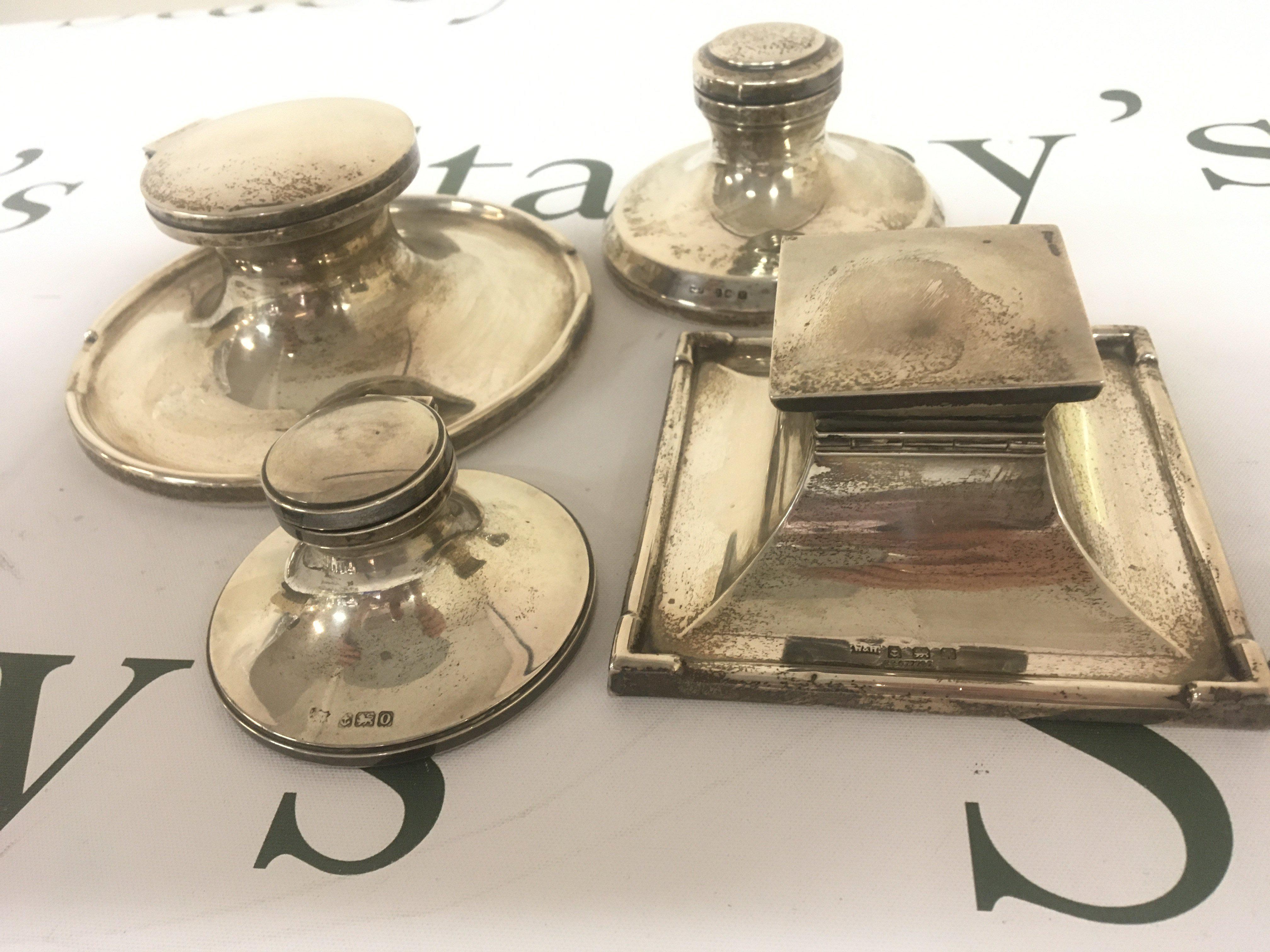 Four Silver Capstan type silver ink wells one of square shape with Birmingham 1921 hallmarks and three round ink wells (4)