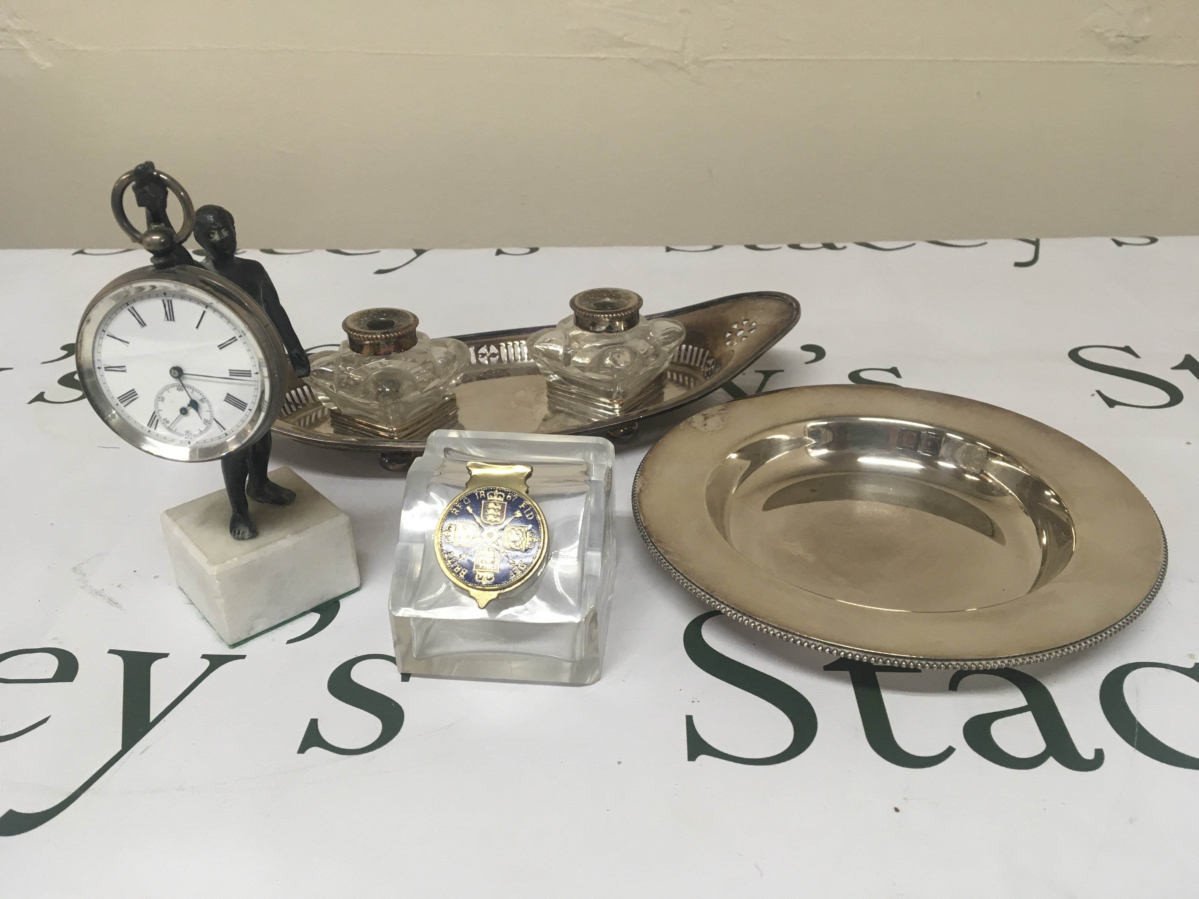 A Silver cased key wind watch a hanging on small figure with marble base silver plated pen tray an ink well and one other dish