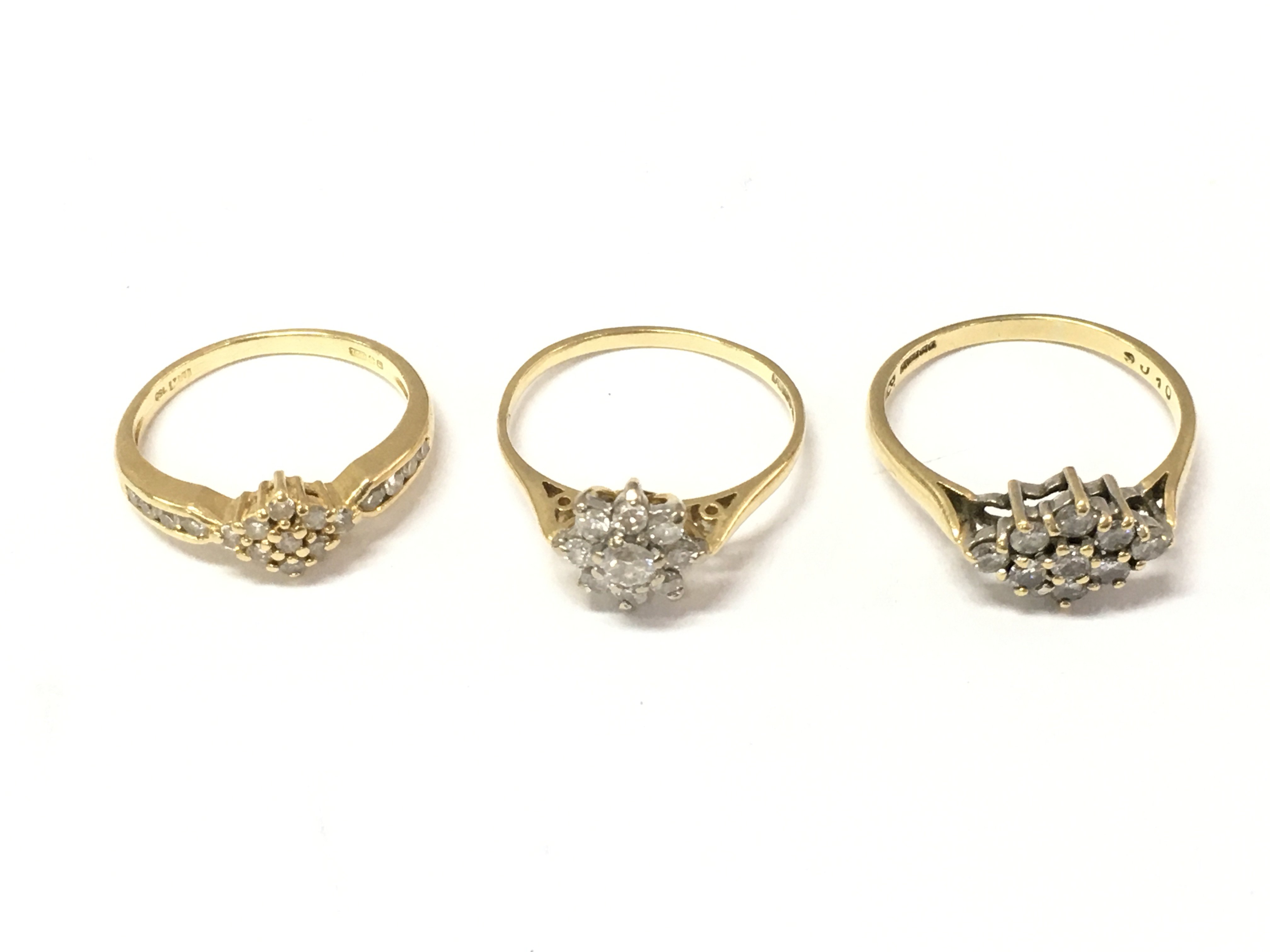 Three 18ct gold diamond cluster rings. Sizes J 1/2 M 1/2 and O. 7.19g Postage A