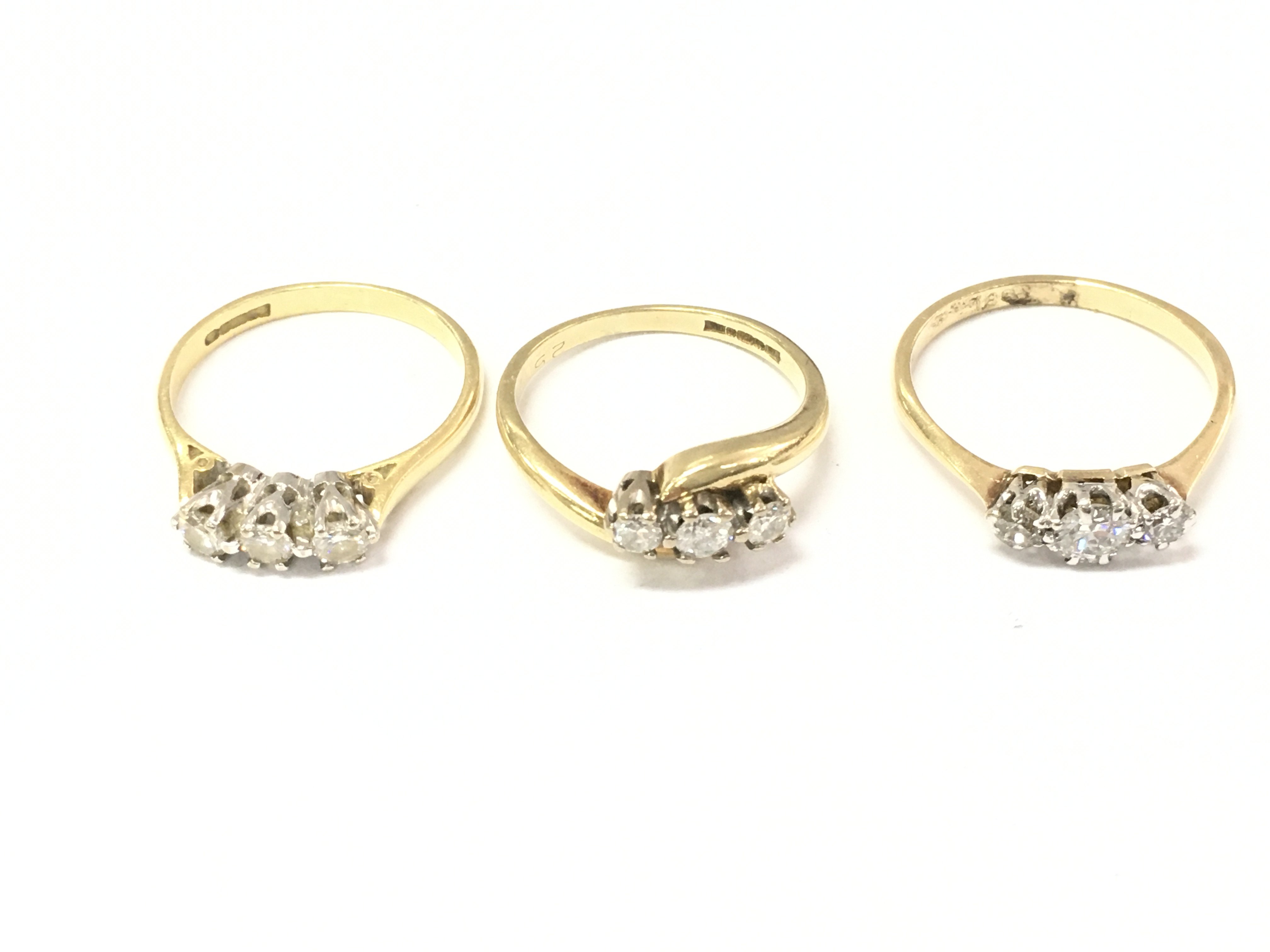 Three 18ct gold three stone diamond rings. Sizes K L and L 1/2 7.5g