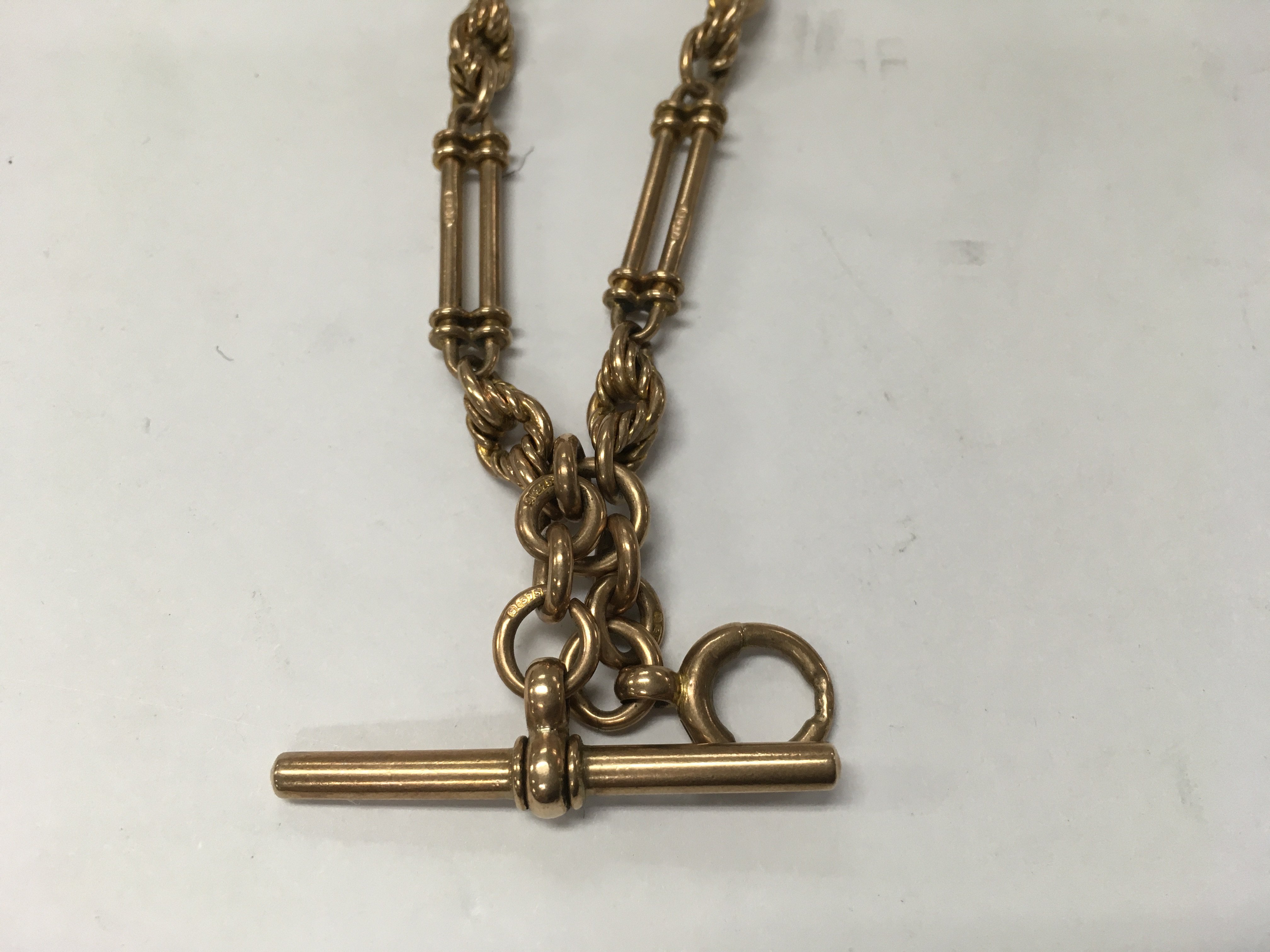 A 9ct gold watch chain with attached 37.6 grams