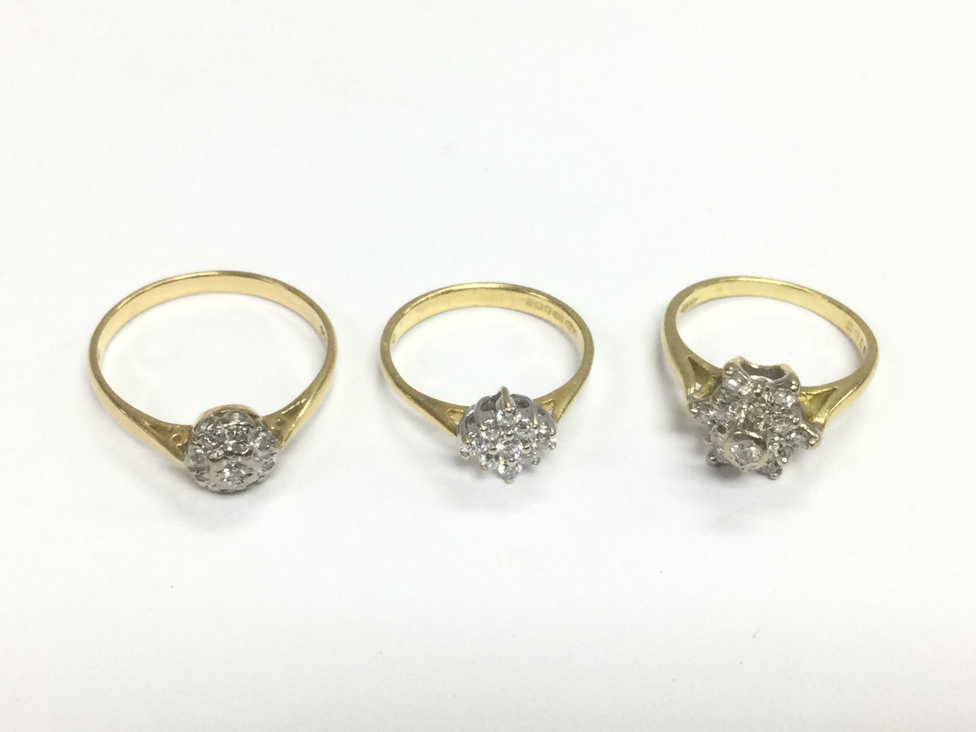 Three 18ct gold diamond cluster rings, approx sizes H, H-I and P. Approx total weight 7.2g. Shipping category A.