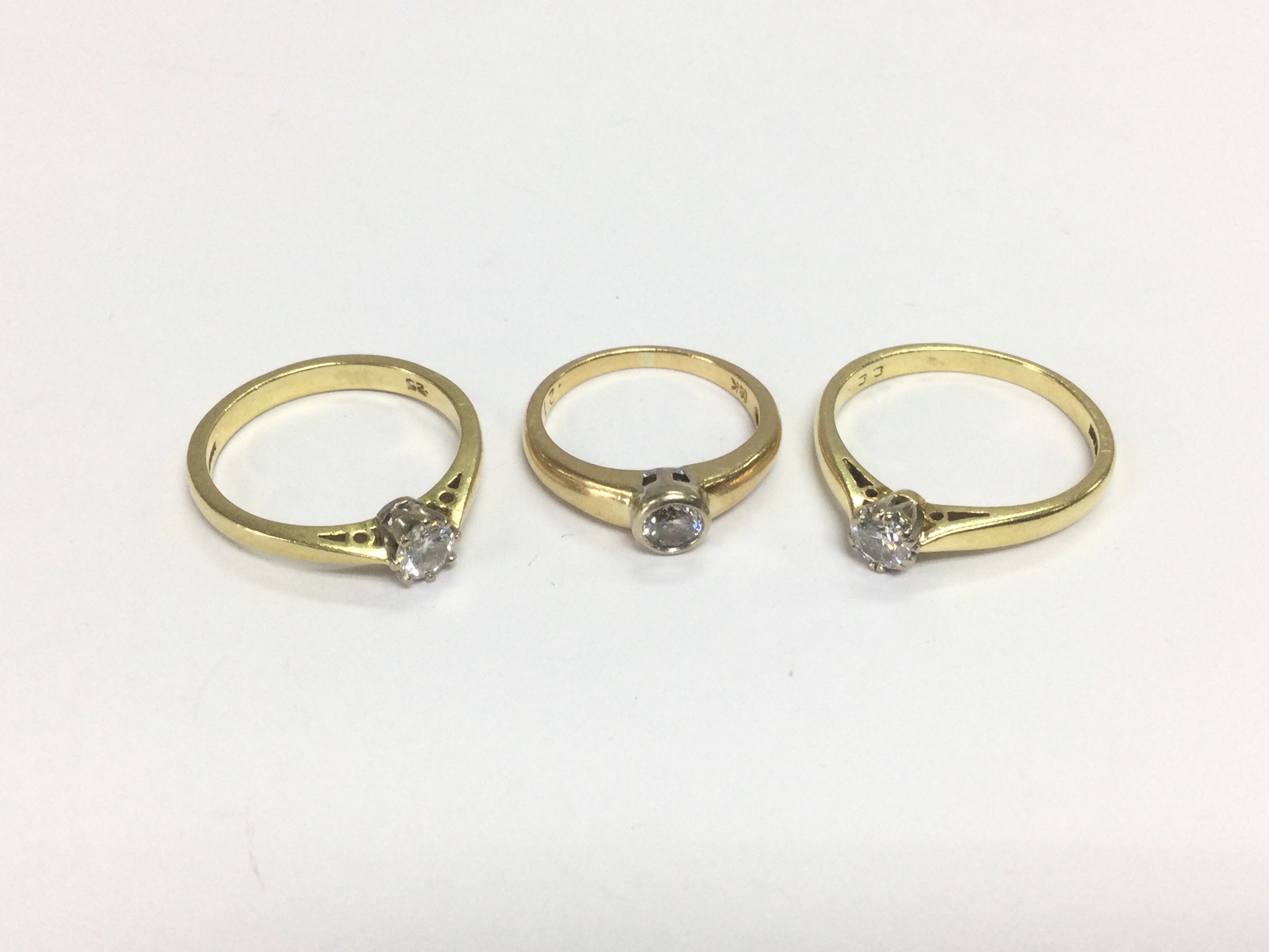 Three 18ct gold solitaire diamond rings, approx sizes H. M and O. Total approx 9g. Shipping category A.