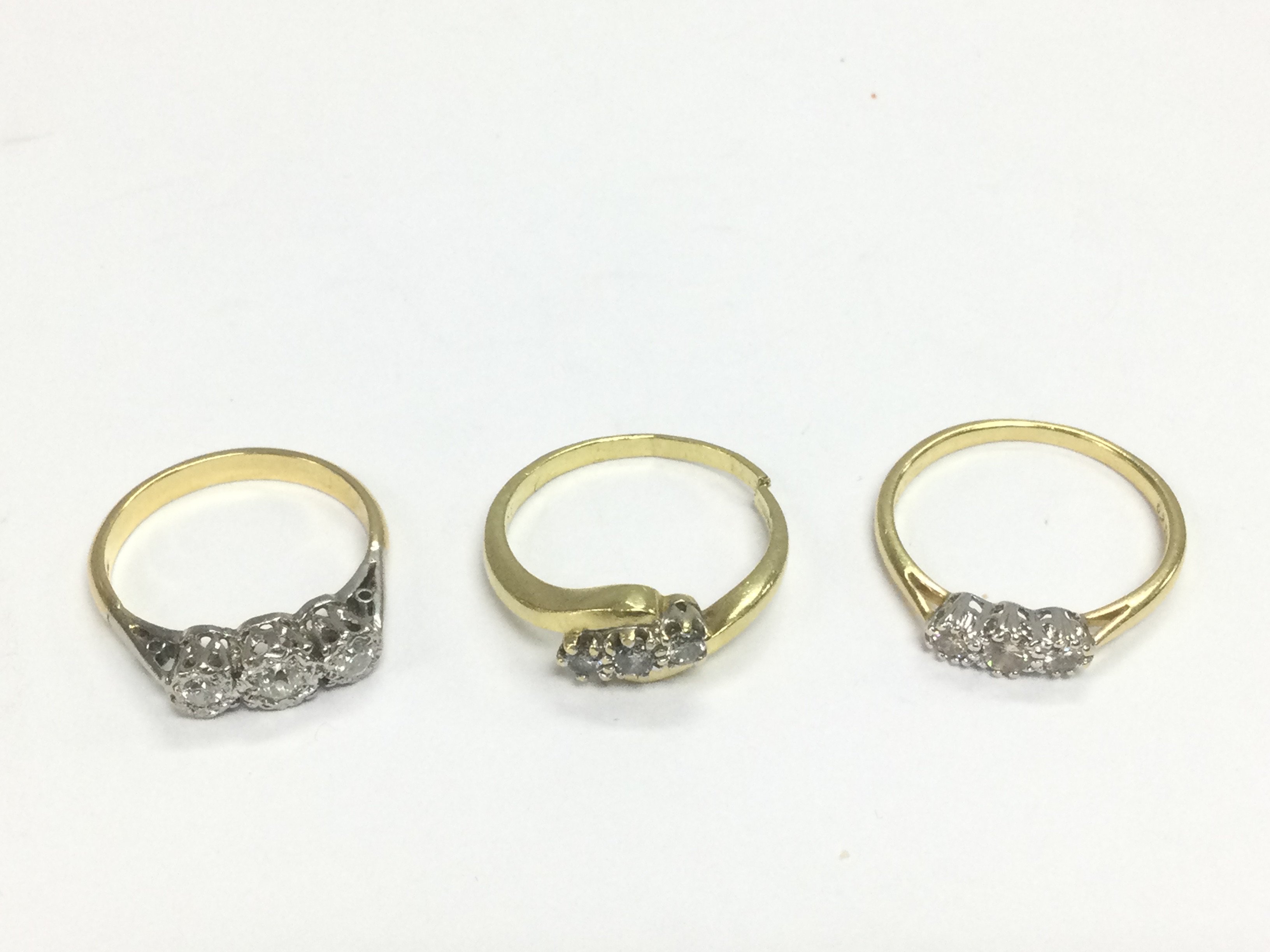 Three 18ct gold three stone diamond rings, approx sizes M, P and Q. Shipping category A. Approx total 9g. Shipping category A.