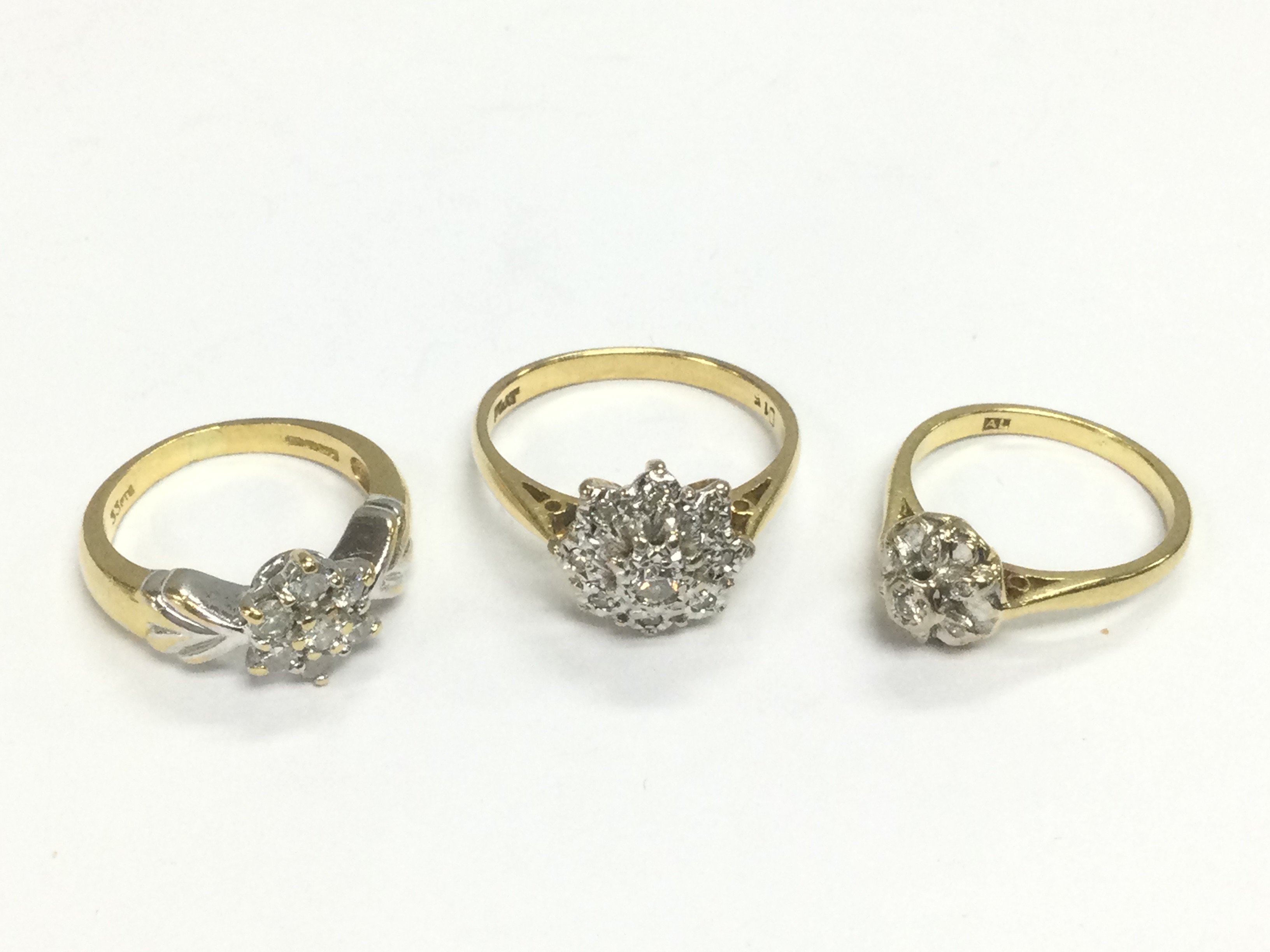 Three 18ct gold diamond cluster rings, approx sizes I and O. Total approx weight 11g. Shipping category A.
