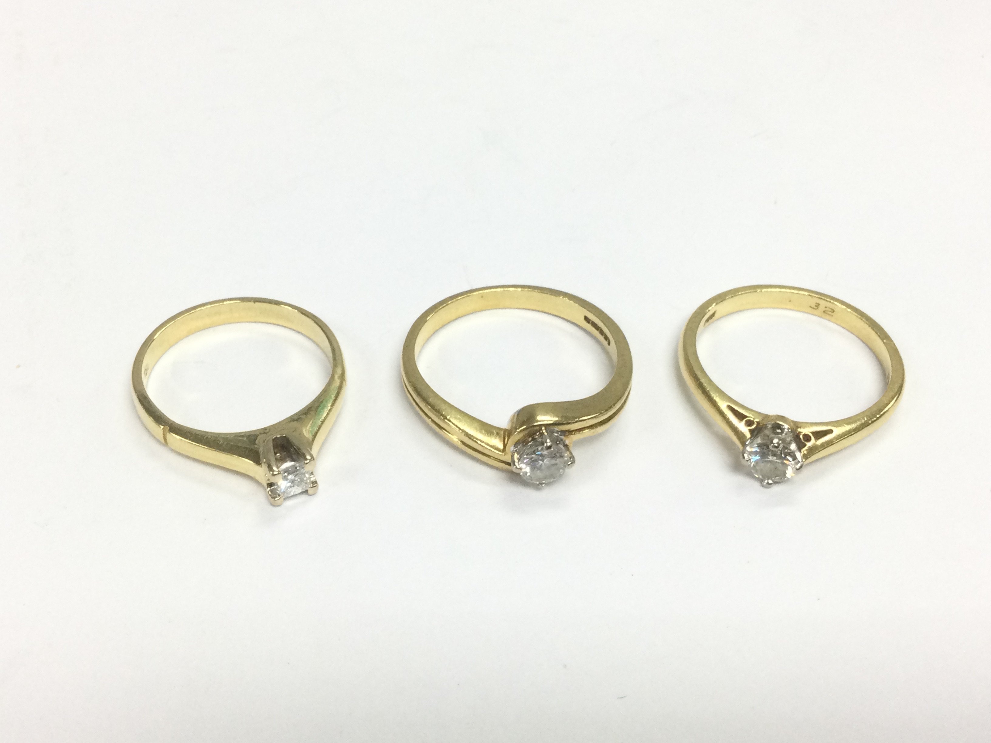 Three 18ct gold diamond solitaire rings, approx sizes J-K, N and O. Total approx 10g. Shipping category A.