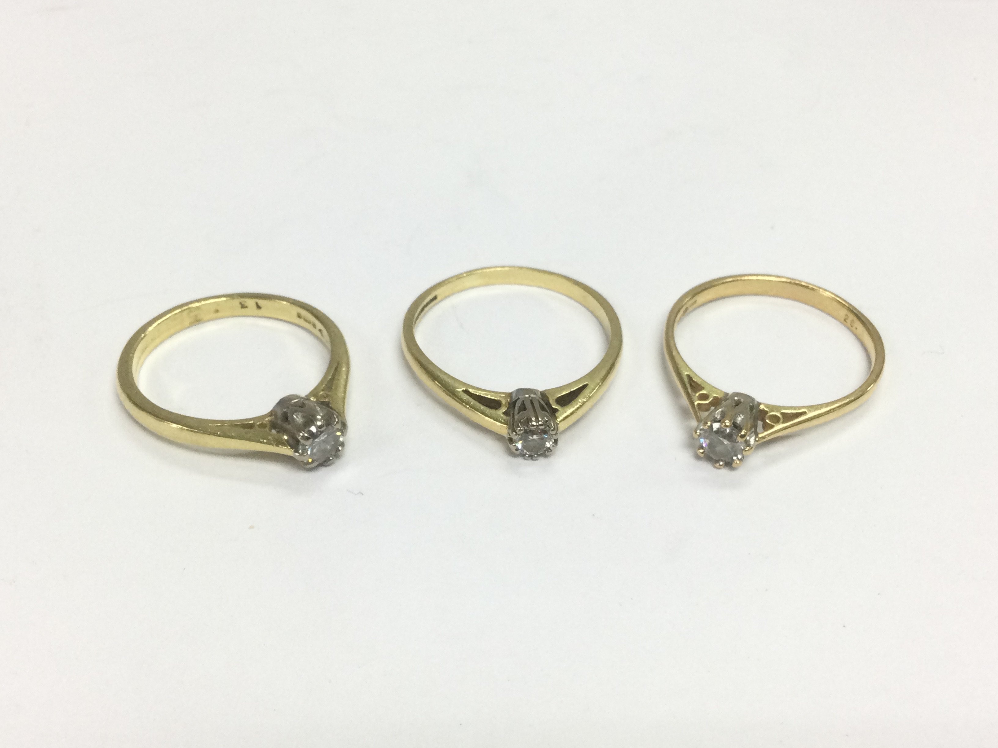 Three 18ct diamond solitaire rings, approx sizes L, O and N. Total approx 7.6g. Shipping category A.
