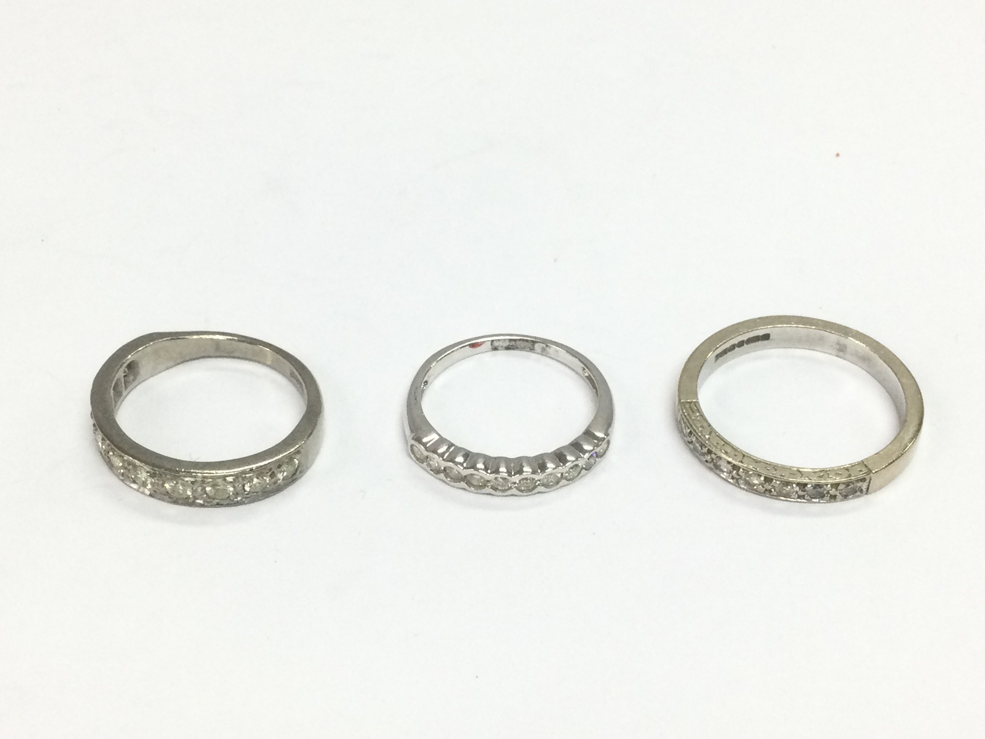 Three 18ct white gold half hoop rings, approx sizes I, L and O. Total approx 9.3g. Shipping category A.