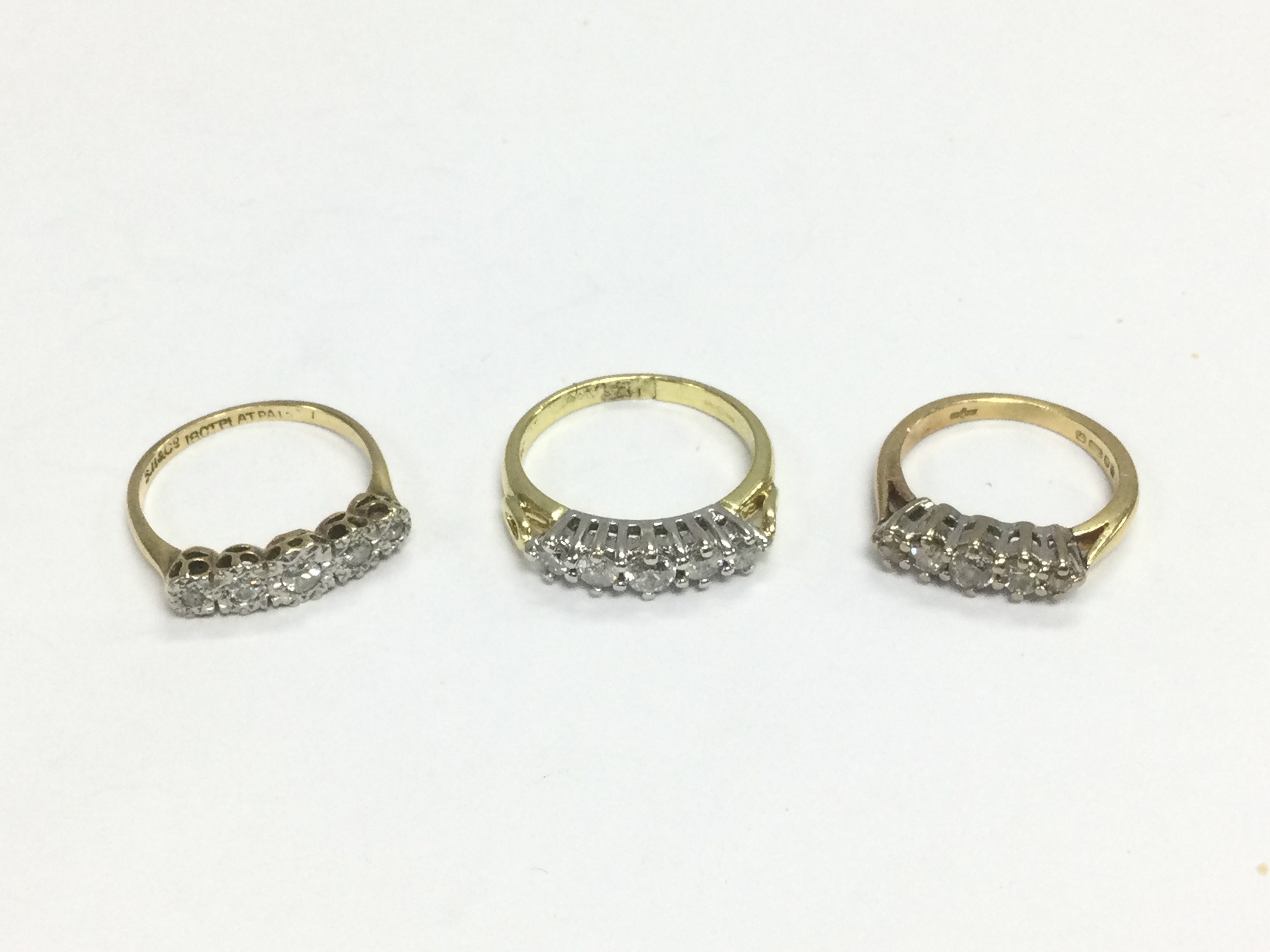 Three 18ct gold five stone diamond rings, approx sizes J, K-L and G-H. Approx total 9.4g. Shipping category A.