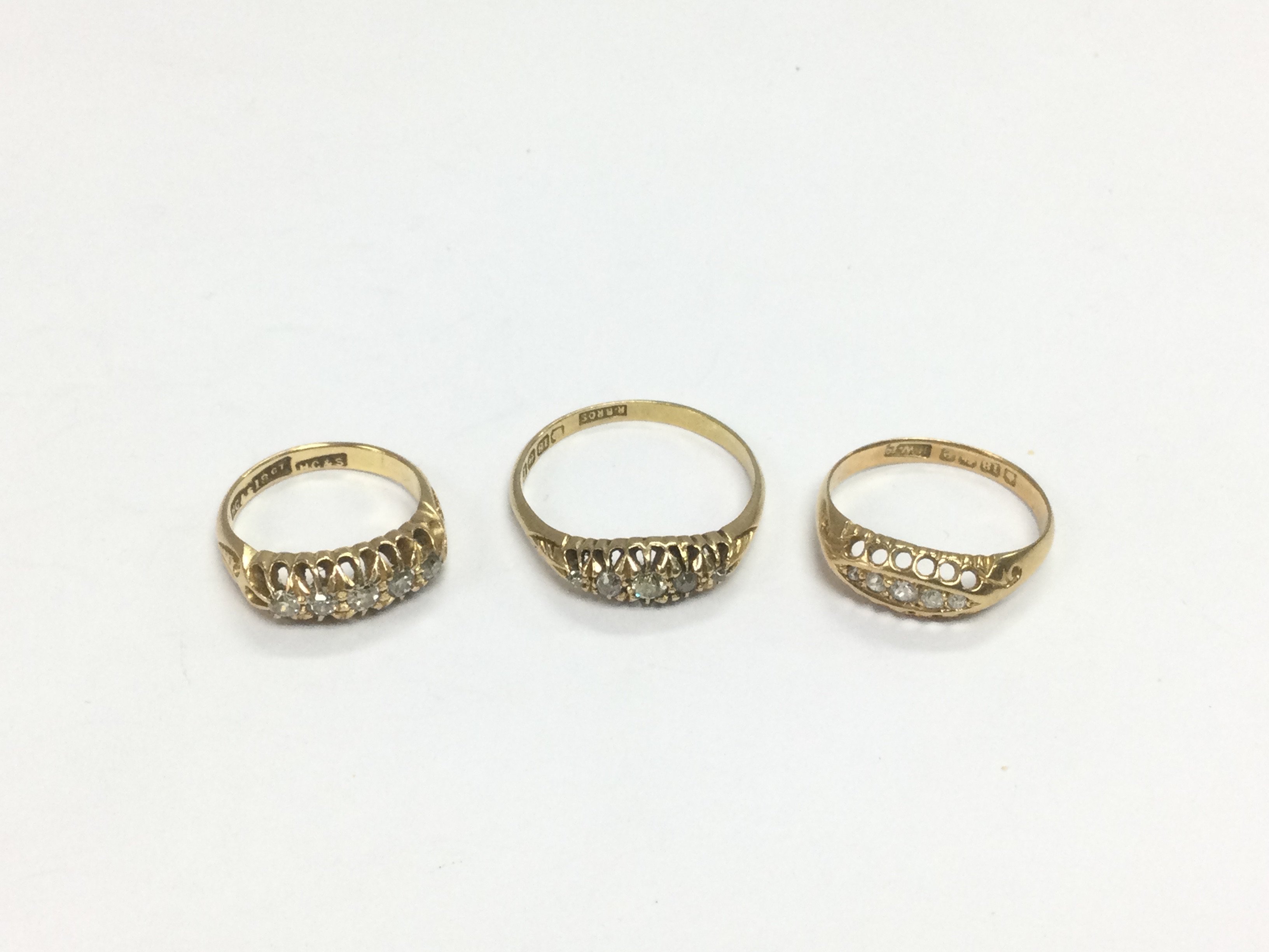 Three 18ct gold five stone diamond rings, approx sizes I, S and L-M. Approx total 9.4g. Shipping category A.