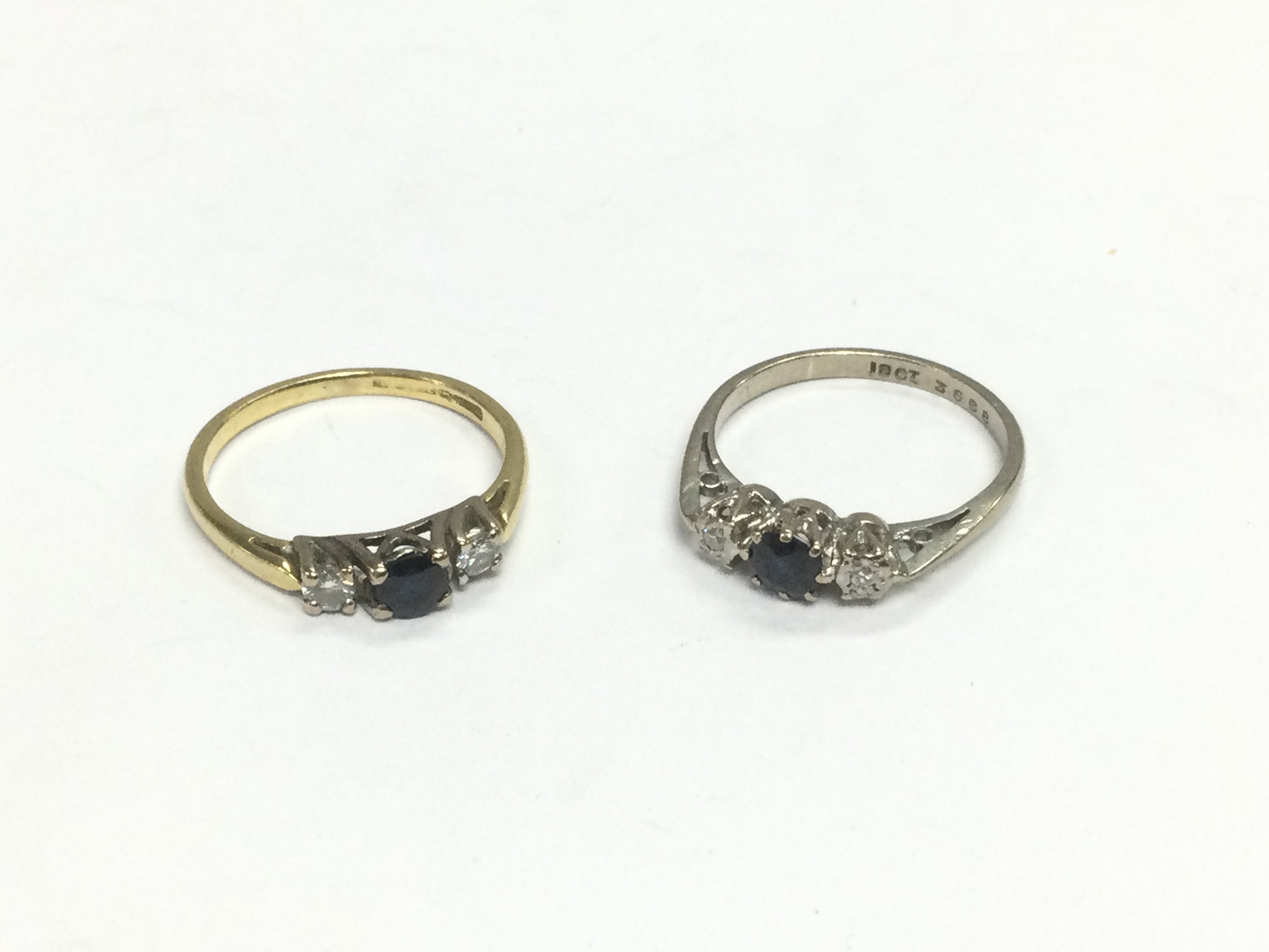 Two 18ct gold three stone diamond and sapphire rings, approx size K. Total approx 4.5g. Shipping category A.