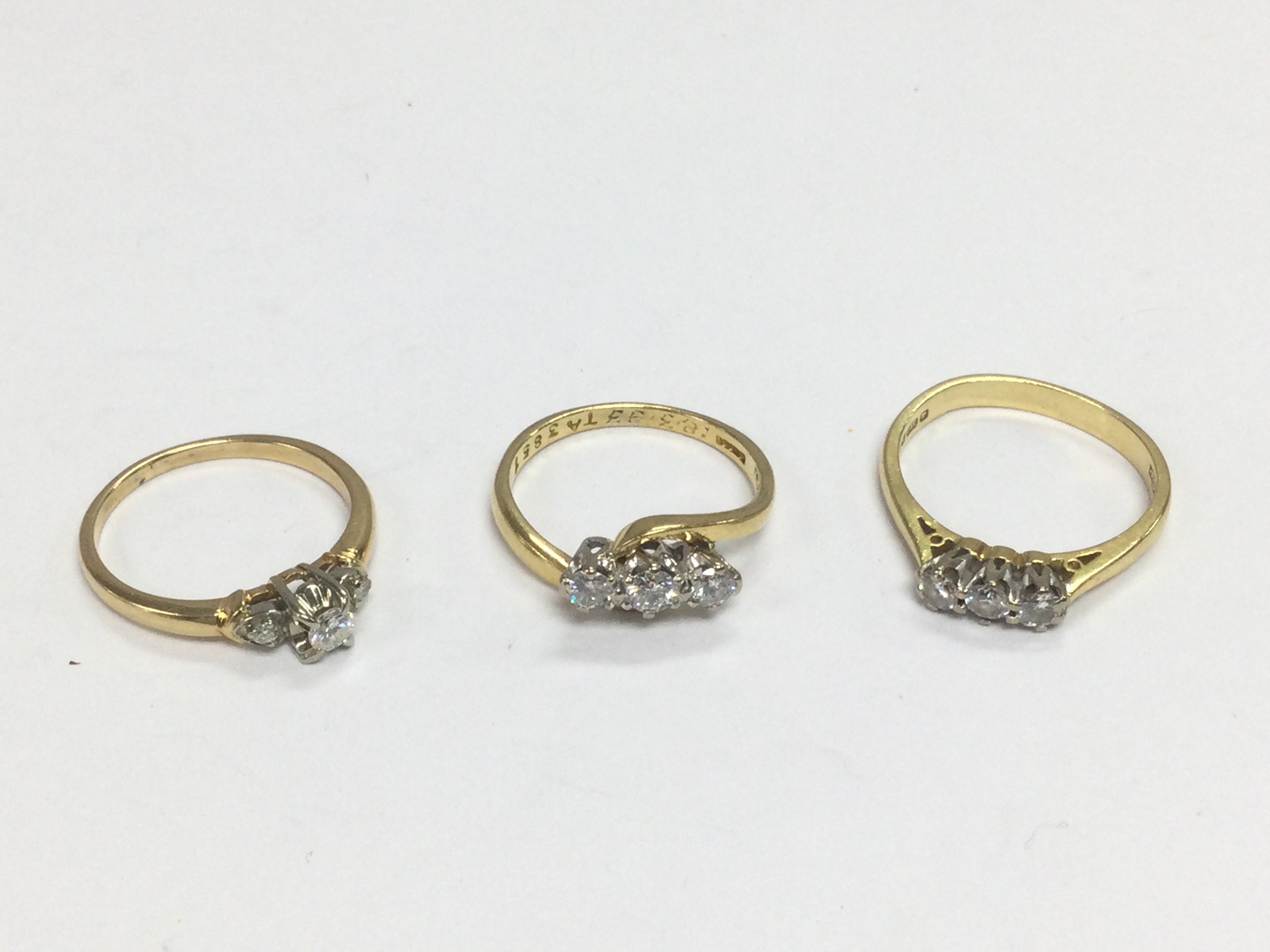 Three 18ct gold three stone diamond ring, approx sizes L and L-M. Total approx 8.4g. Shipping category A.