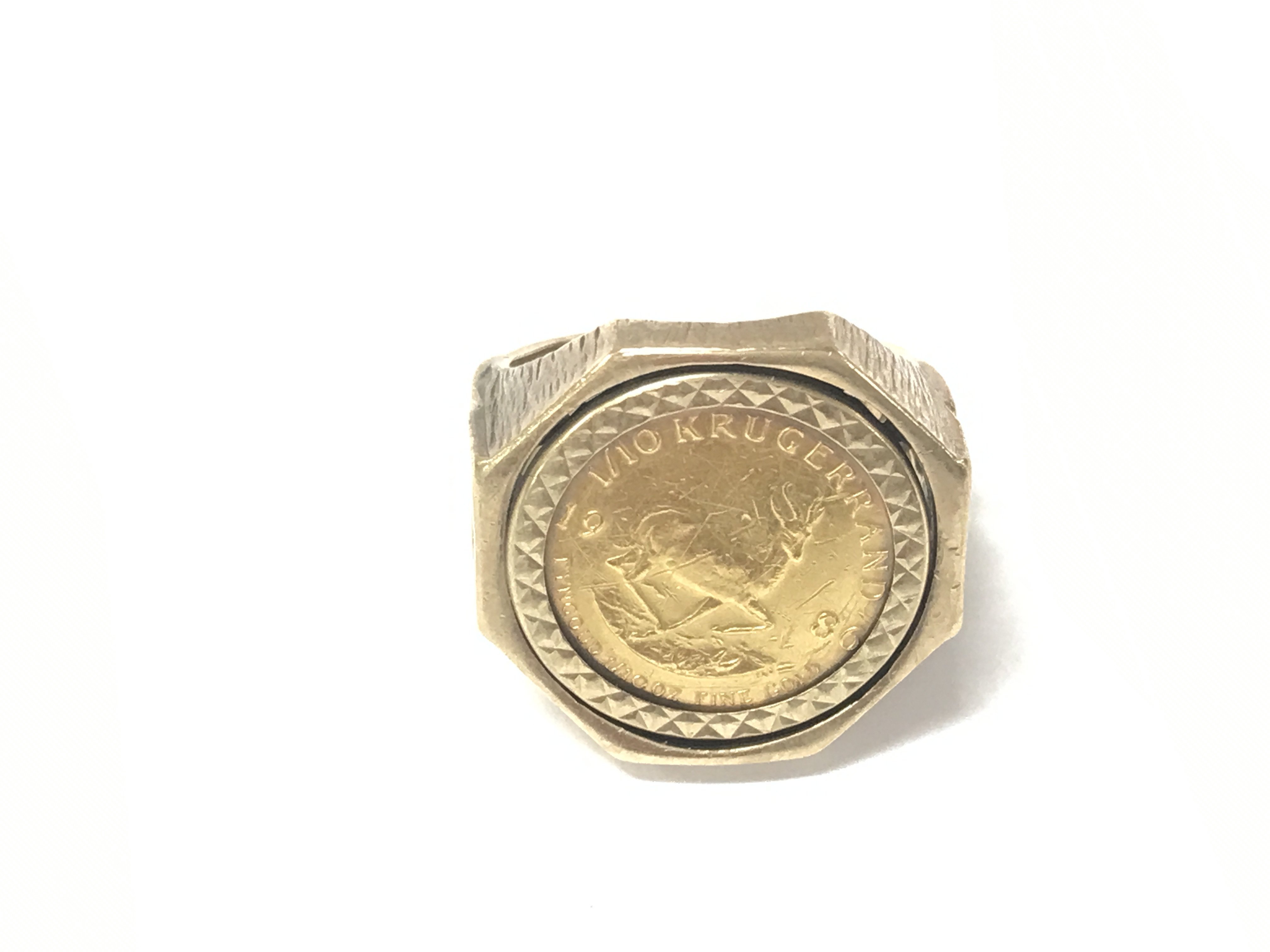 A 9ct gold ring set with a 1/10oz 1986 Krugerrand. Size J 1/2 and 9.29g
