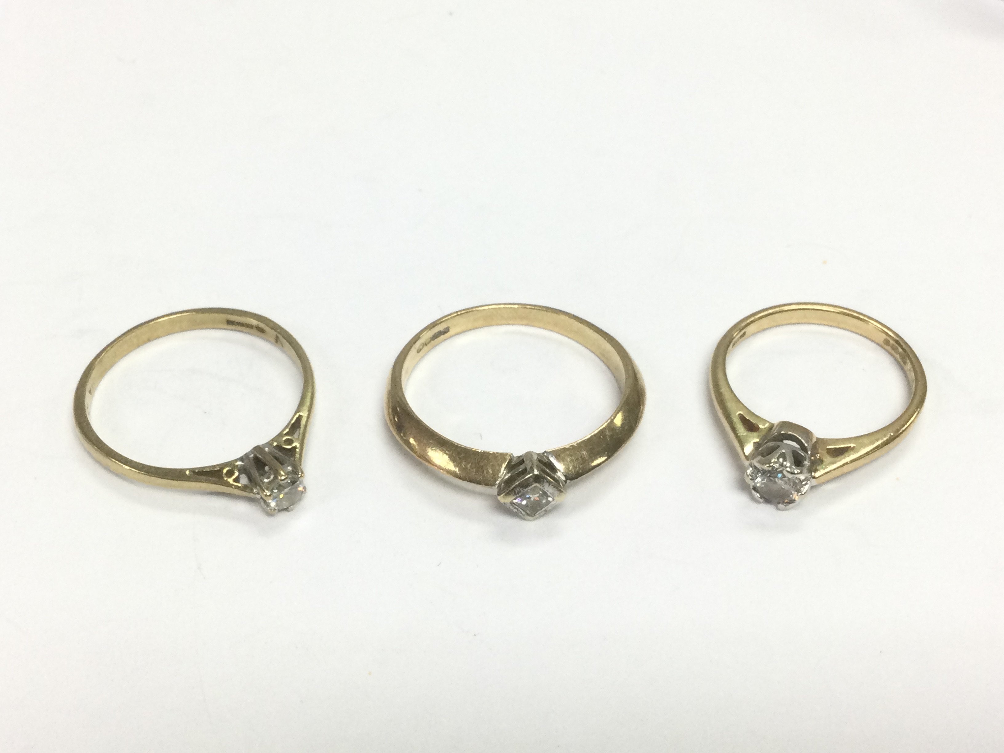 Three 9ct gold diamond solitaire rings, approx sizes J, O and Q. Total approx 5.9g. Shipping category A.