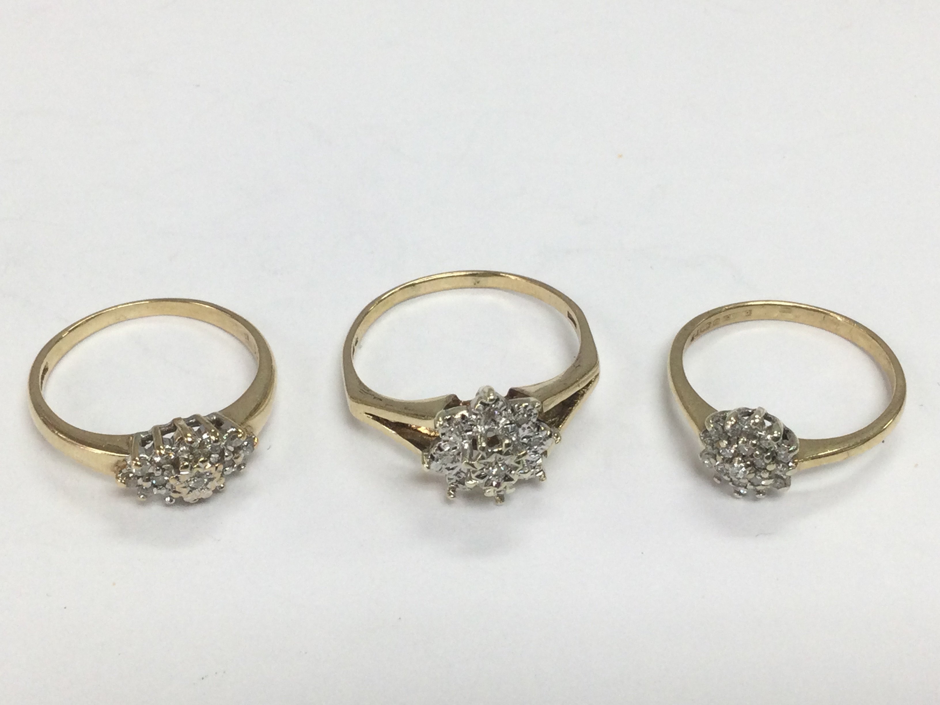 Three 9ct gold diamond cluster rings, approx sizes 5.7g. Total approx 5.7g. Shipping category A.