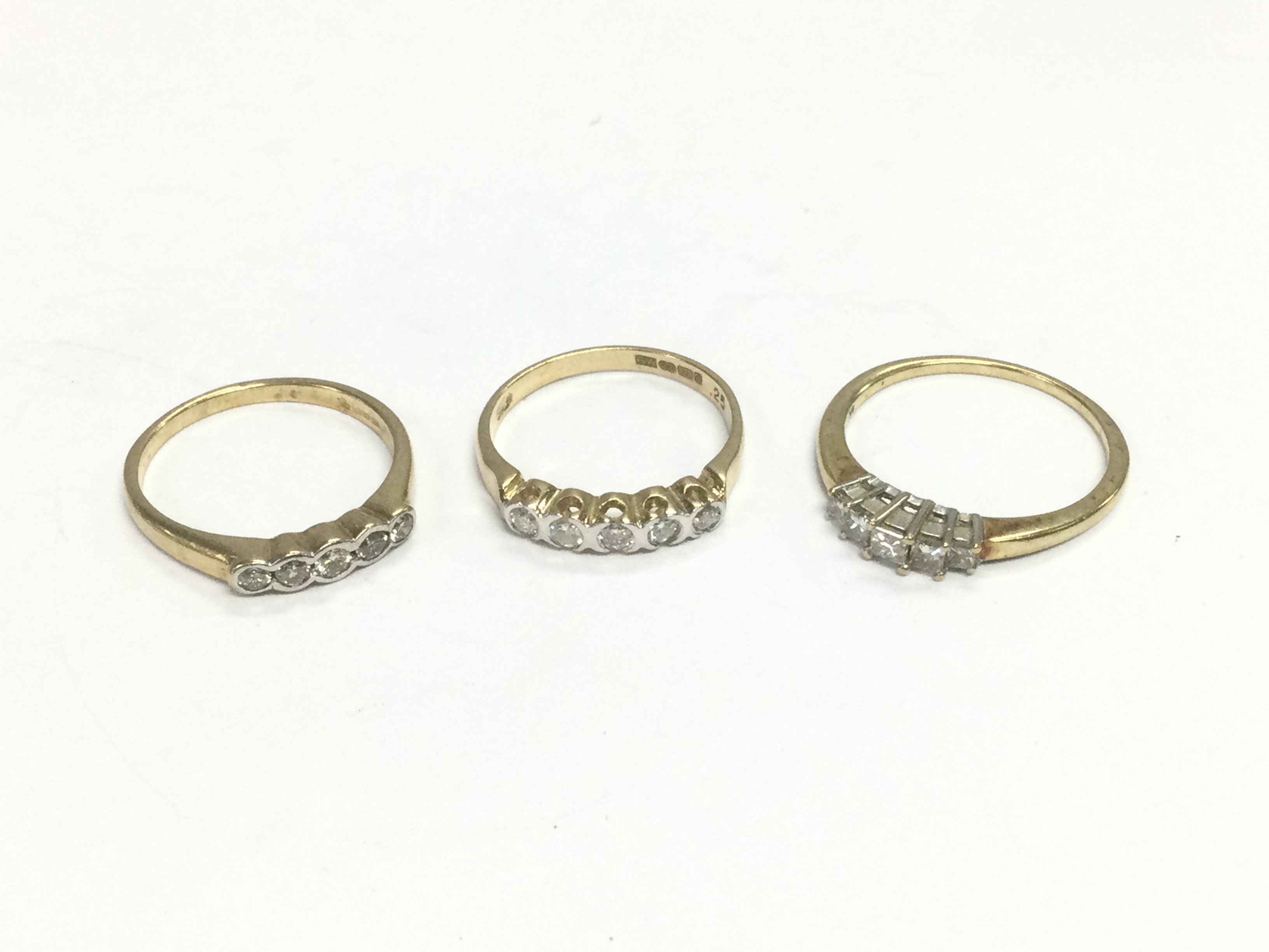 Three 9ct gold five stone diamond rings, approx sizes N, L and P. Total approx 5.6g. Shipping category A.