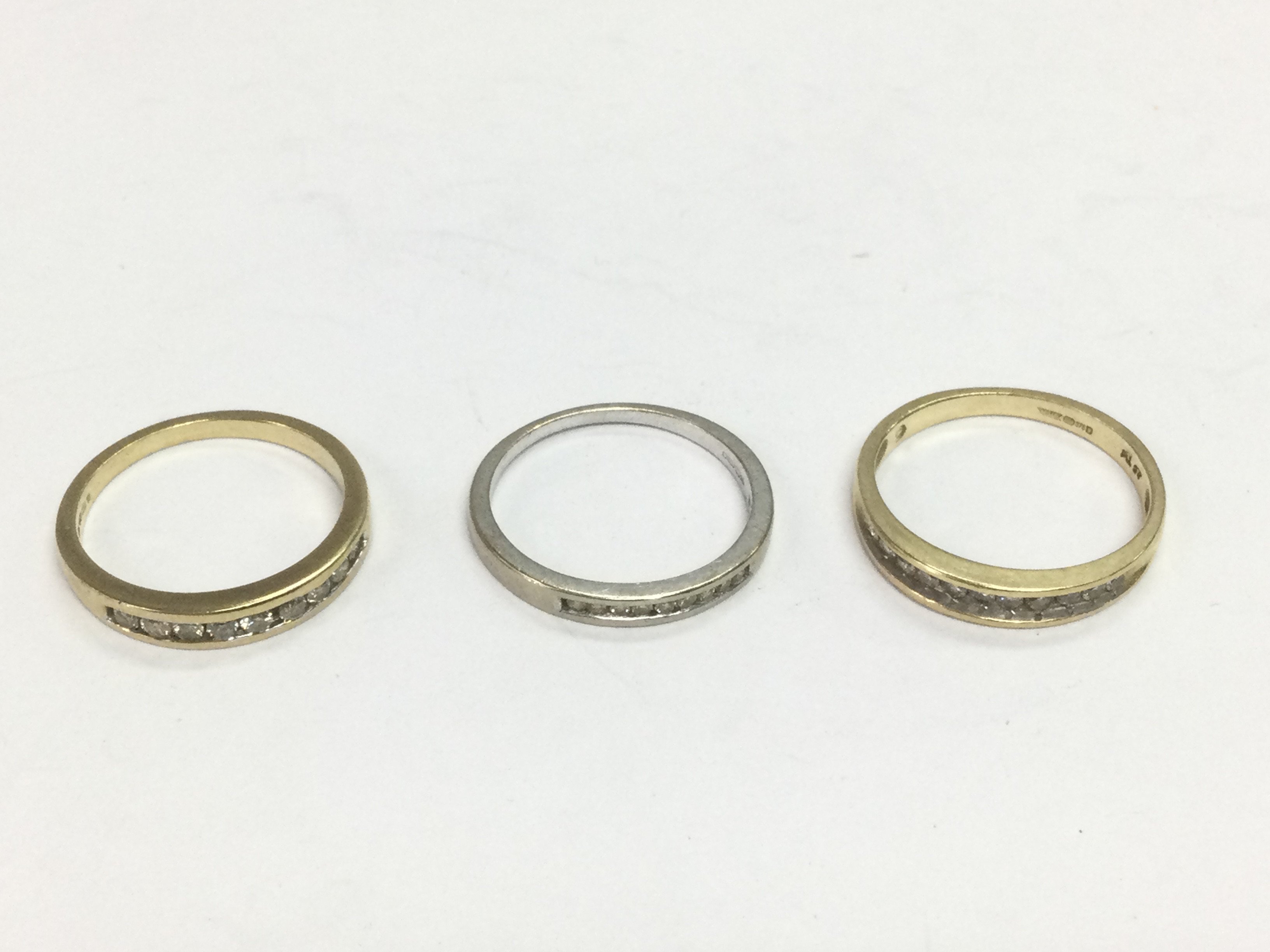Three 9ct gold half hoop diamond rings, approx sizes M and O. Total approx 5.8g. Shipping category A.
