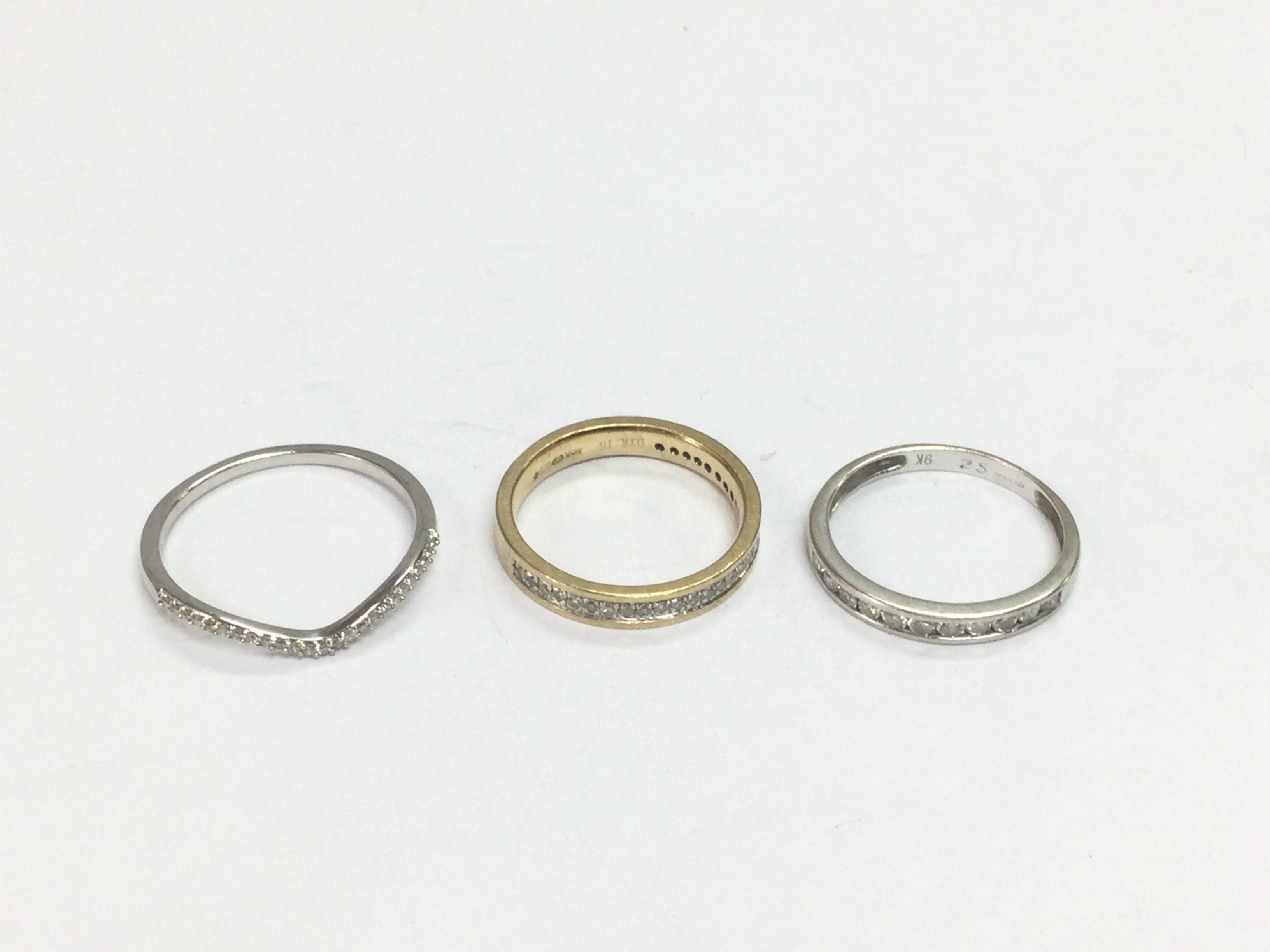 Three 9ct gold half hoop diamond rings, approx sizes N and I. Total approx 4.3g. Shipping category A.