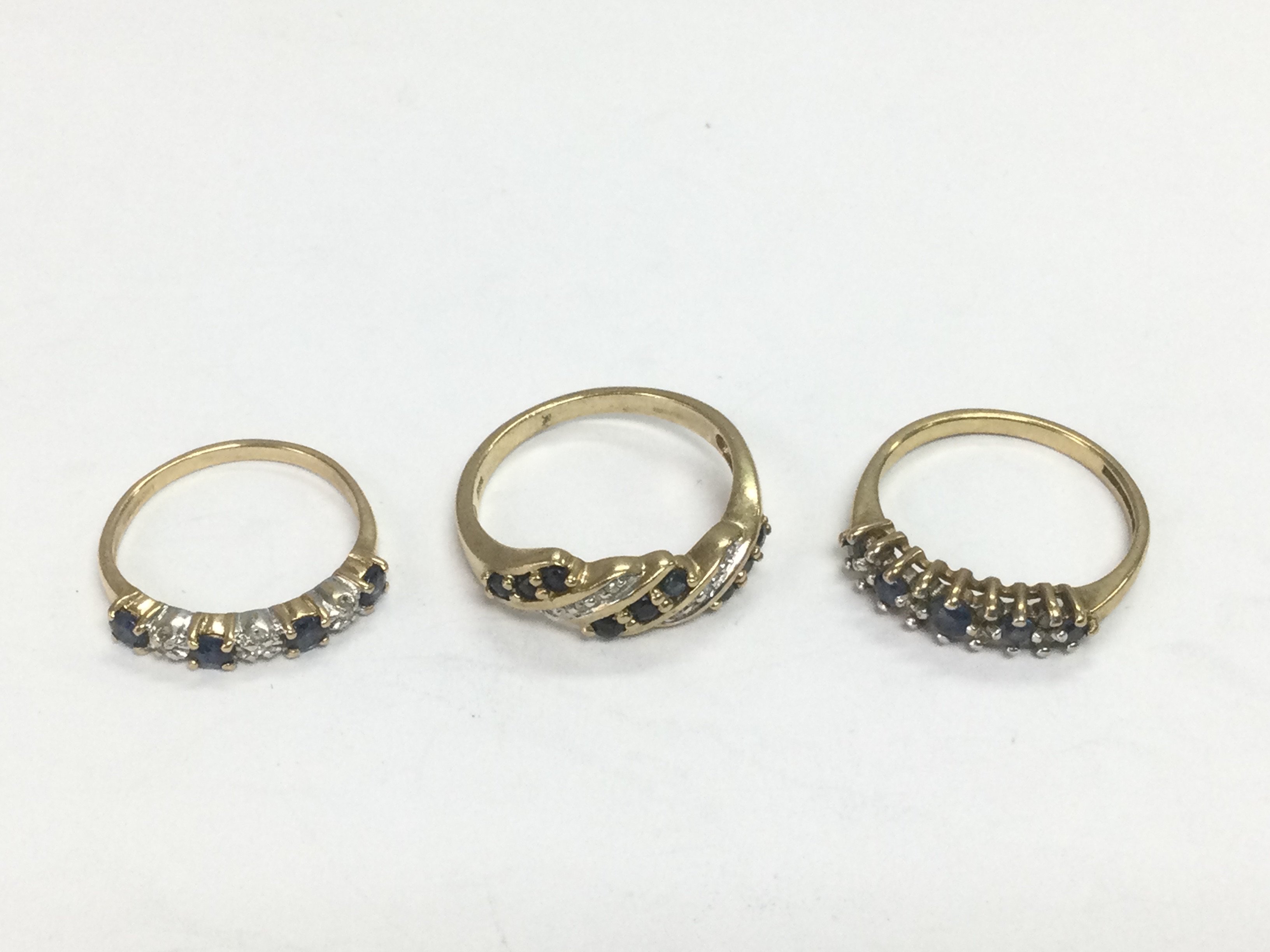 Three 9ct gold rings set with diamonds and sapphires, approx sizes L, I and M. Total approx 5.6g. Shipping category A.