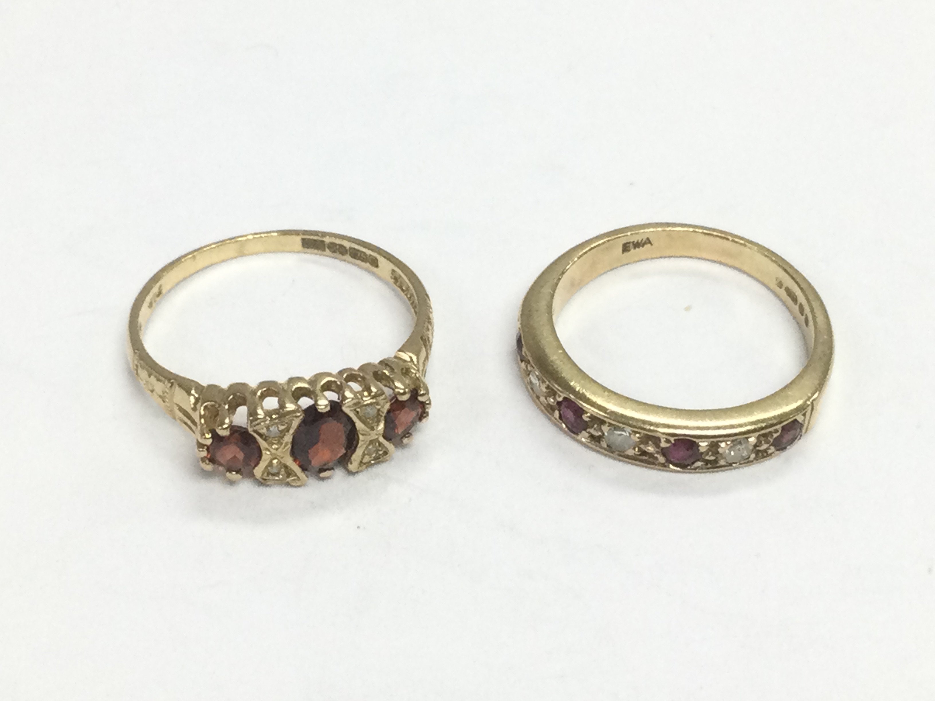 Two 9ct gold rings set with diamonds and garnets, approx sizes J and M. Total approx 4.2g. Shipping category A.
