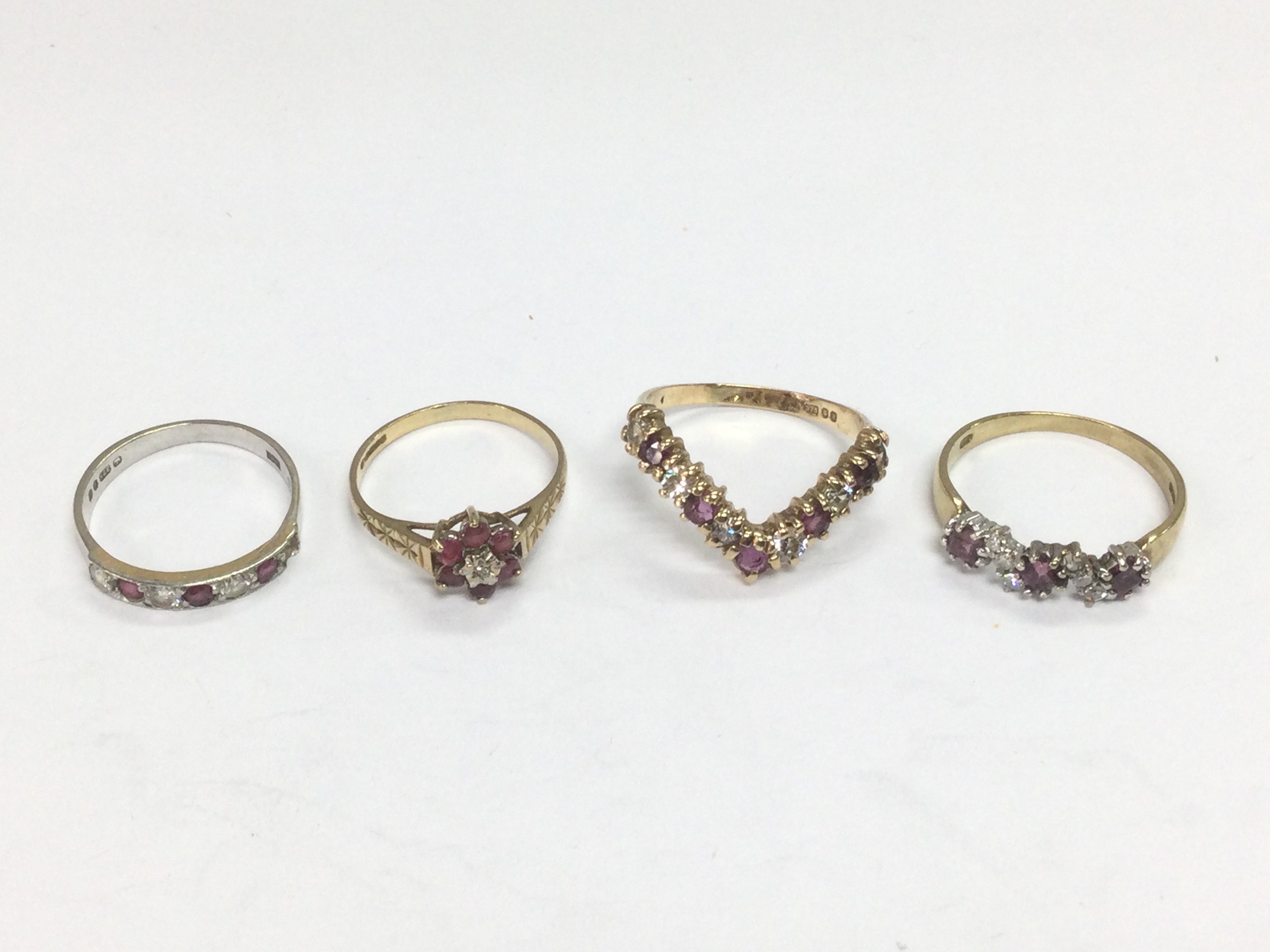 Four 9ct gold rings set with diamonds and rubies, approx sizes L and O. Total approx 7.2g. Shipping category A.