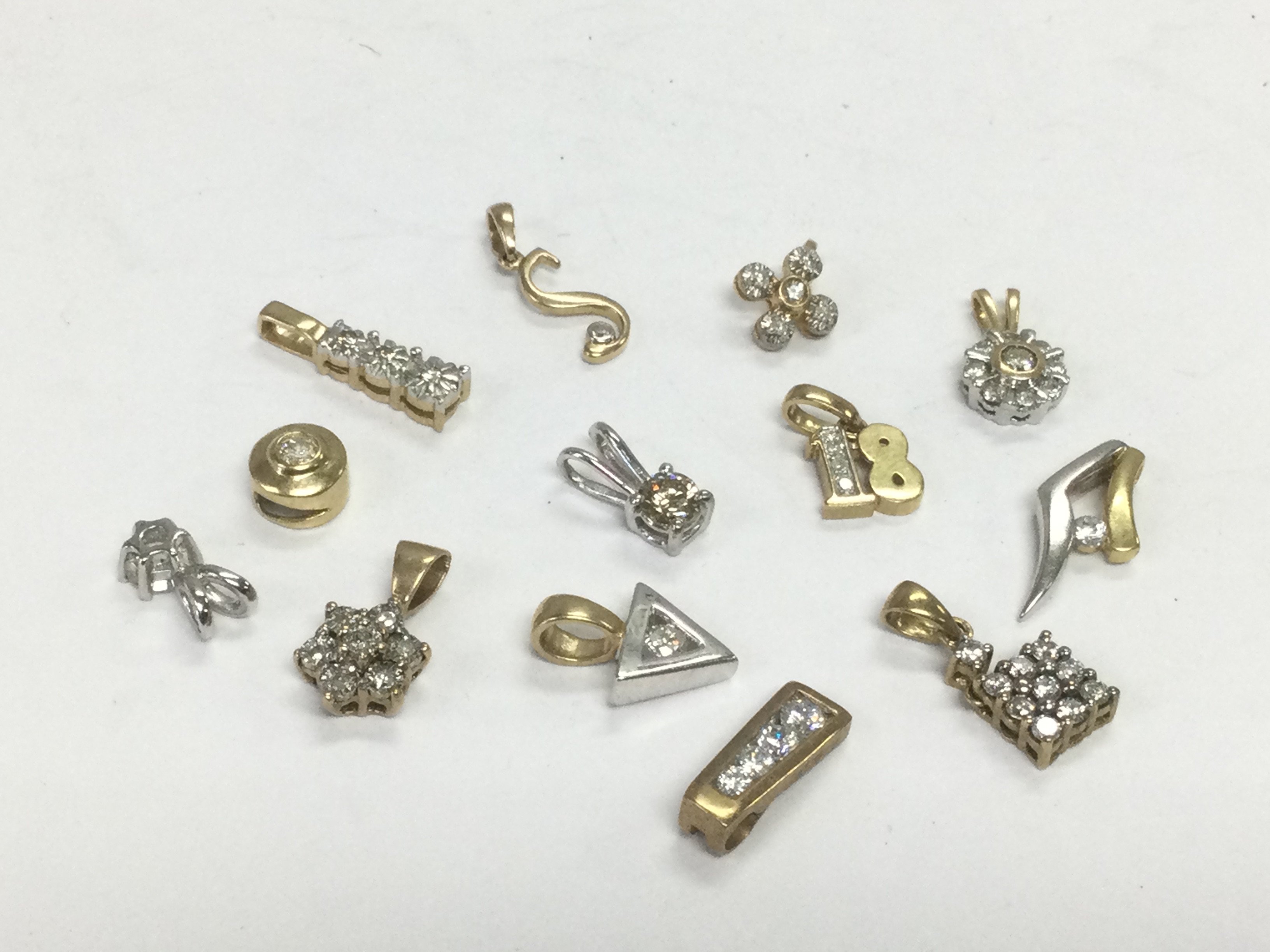 Thirteen 9ct gold and diamond set pendants, total approx 9.3g. Shipping category A.