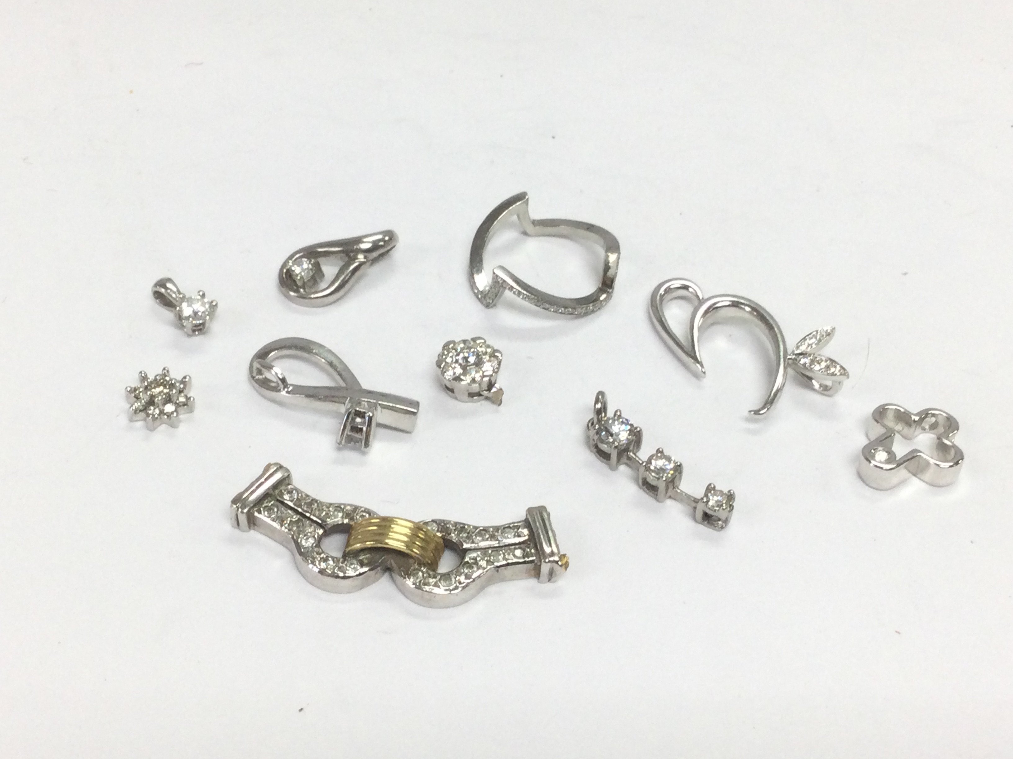 Ten white gold pendants set with diamonds, total approx 11.8g. Shipping category A.