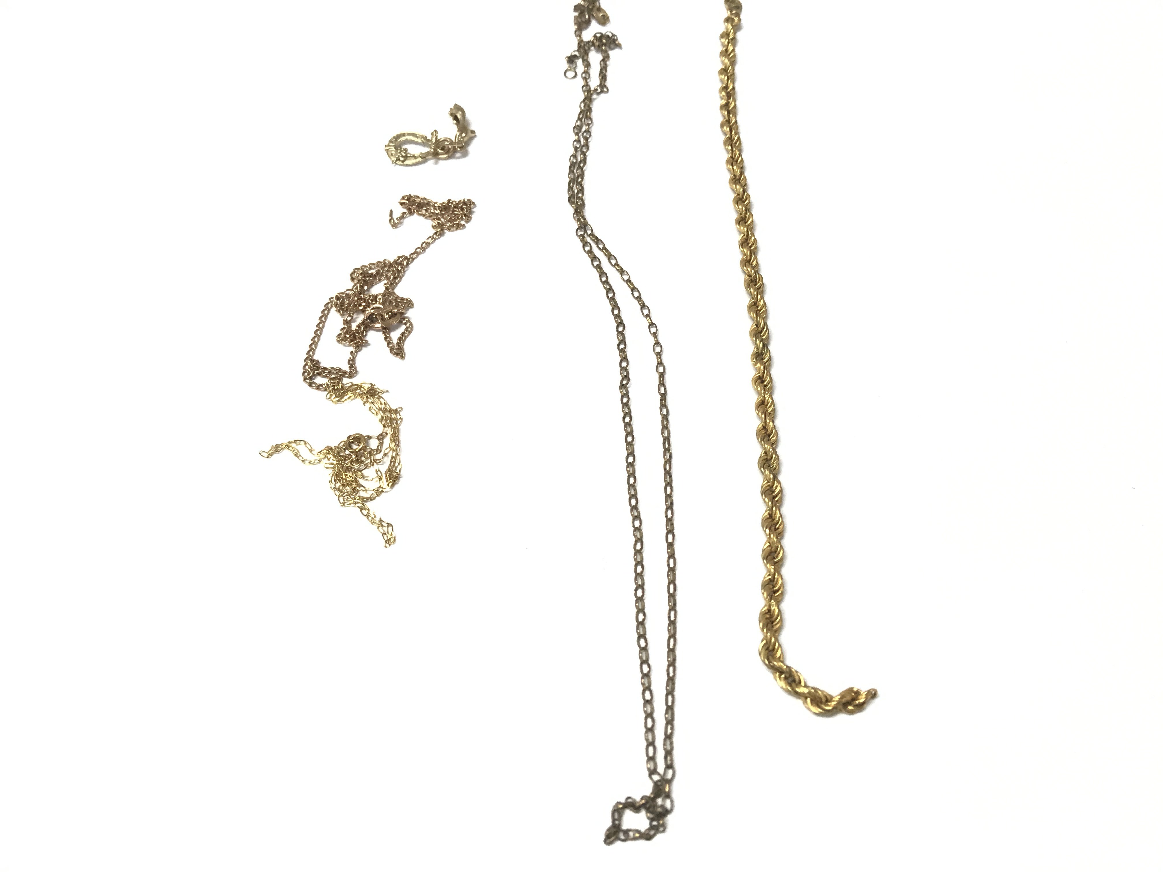 A collection of assorted 9ct gold items including chains and charms some A/F. 7.85g
