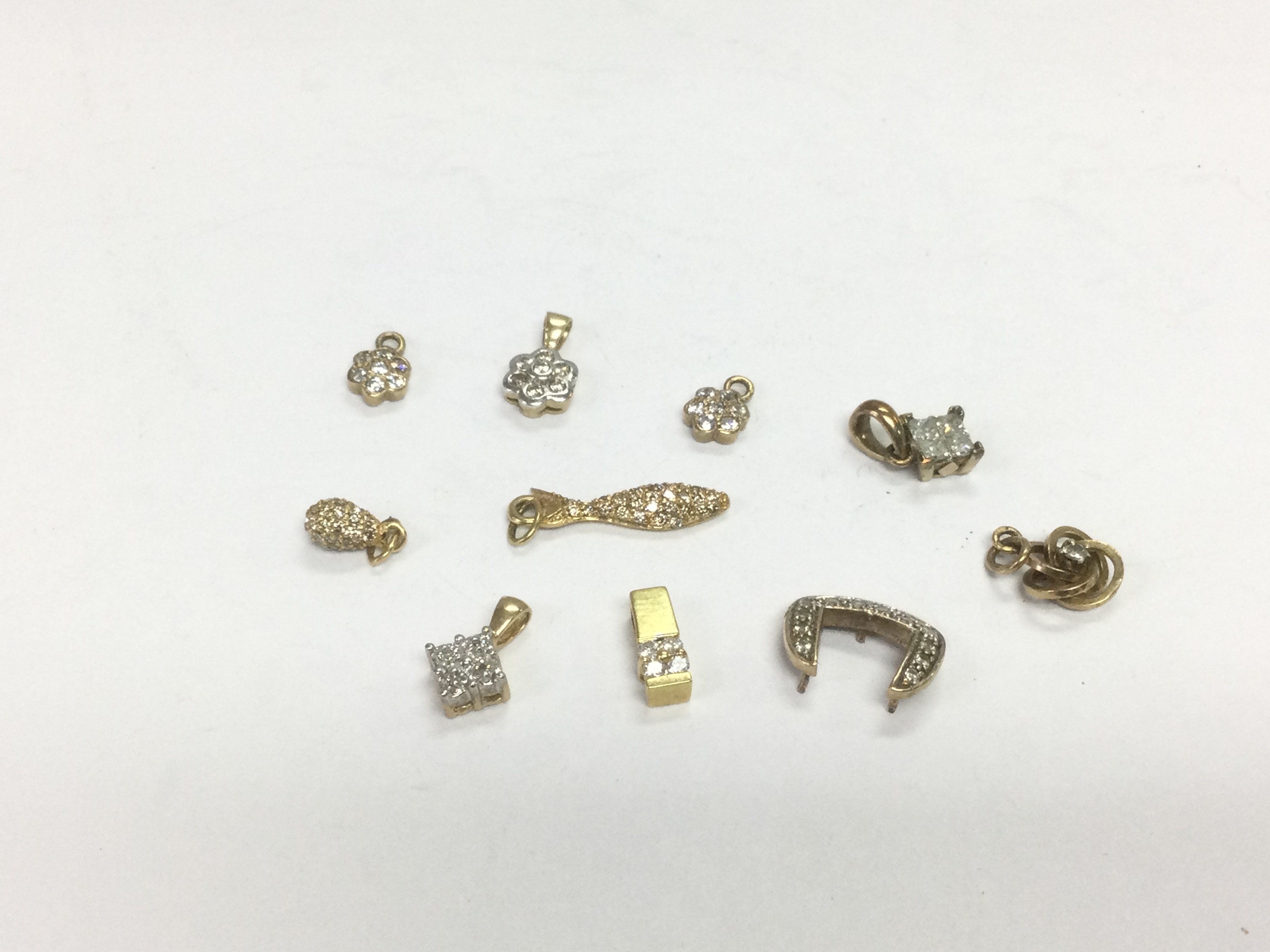 Ten gold diamond cluster pendants, total approx 6.3g. Shipping category A.