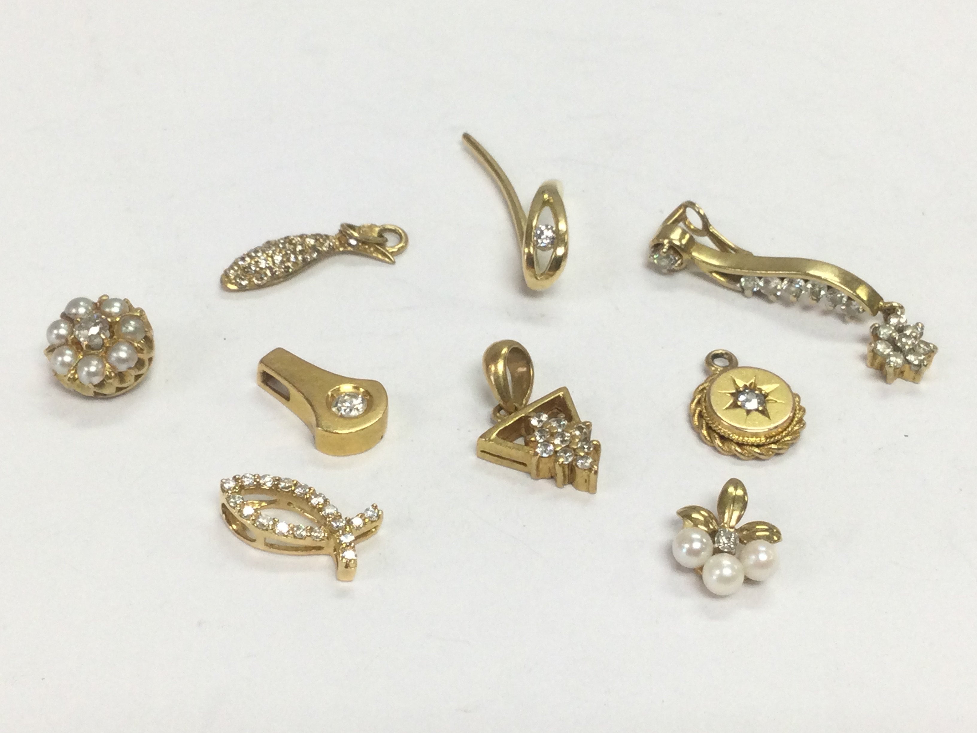 Nine gold diamond cluster pendants, total approx 10.4g. Shipping category A.