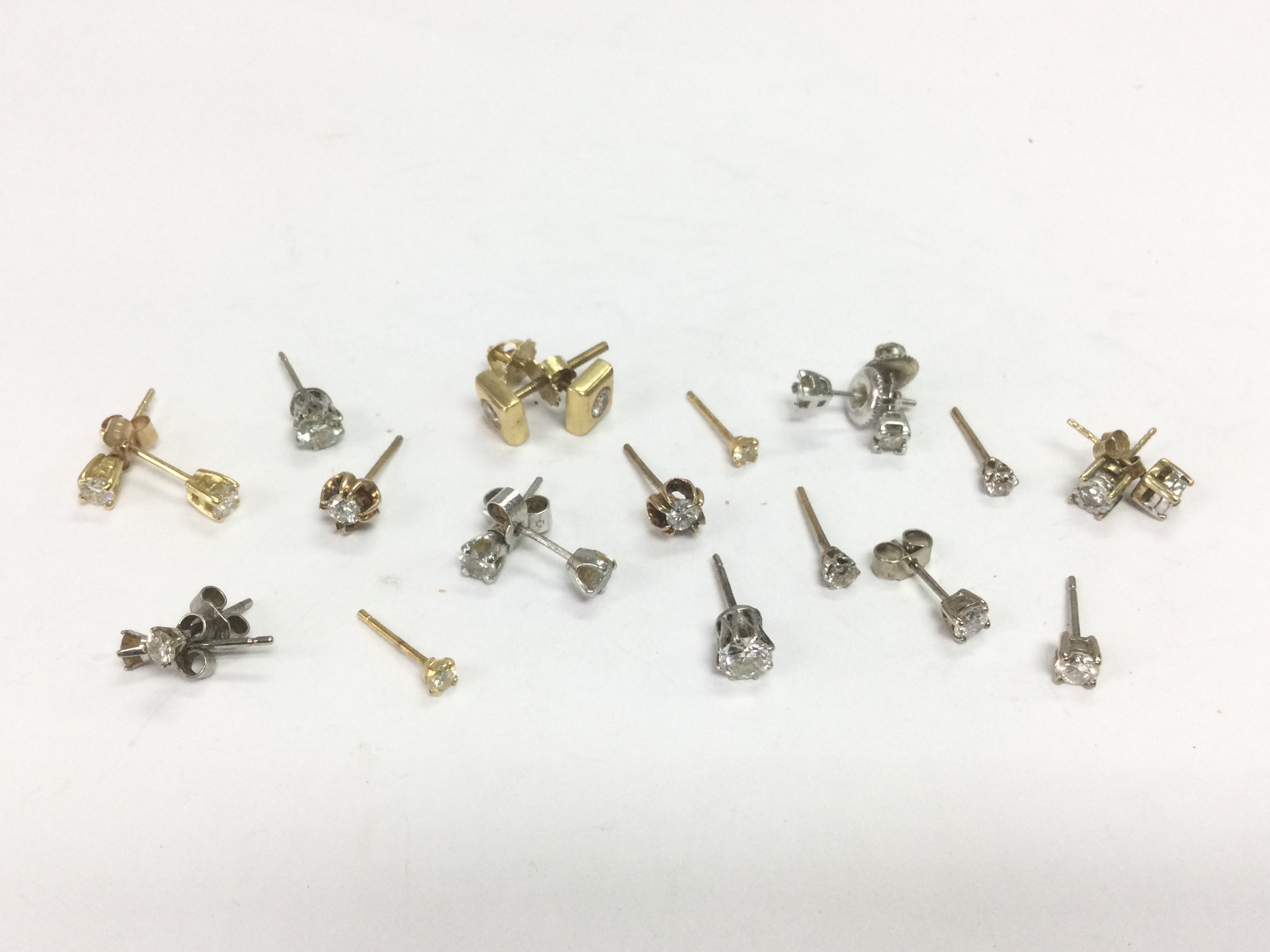 A collection of gold solitaire diamond studs, total approx 10.9g. Shipping category A.